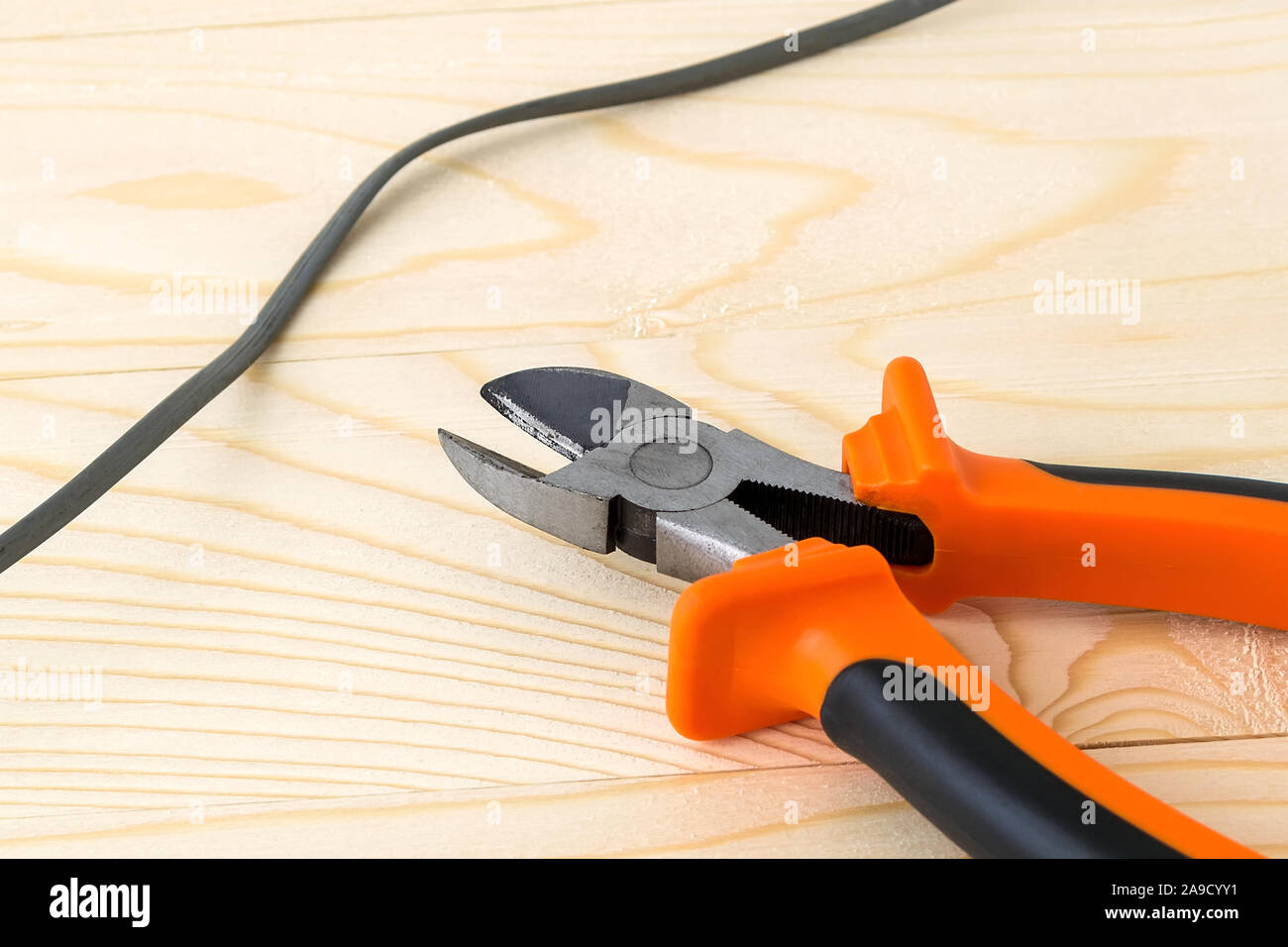 Wire and metall side cutters with orange black rubber handles on a