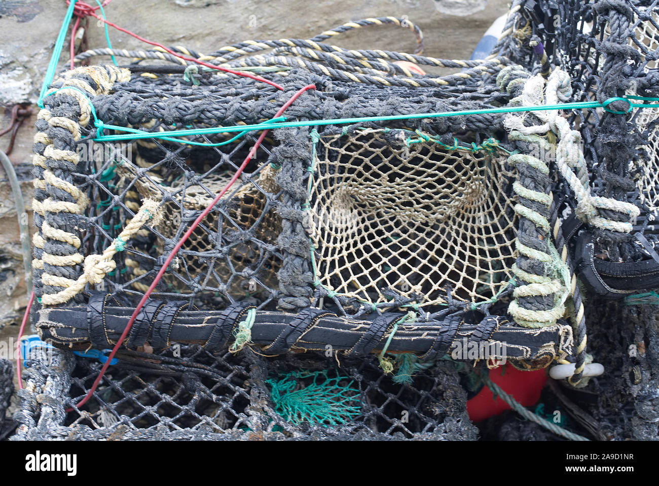 Lobster pots on a fishing harbour in Cornwall, England, UK. Shallow