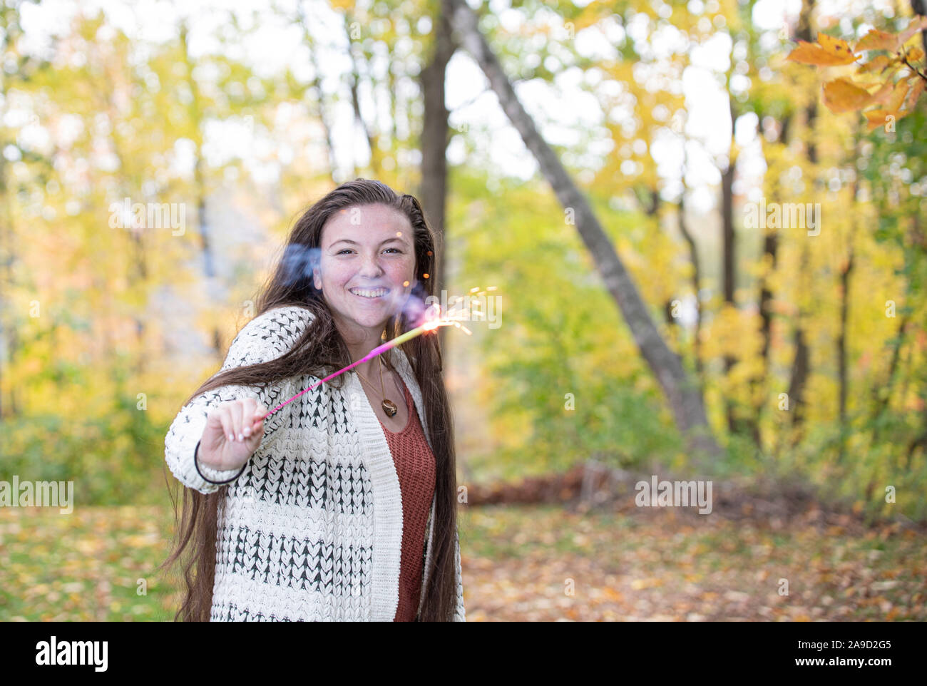 Energetic Teenage Girl with Sparklers Stock Photo