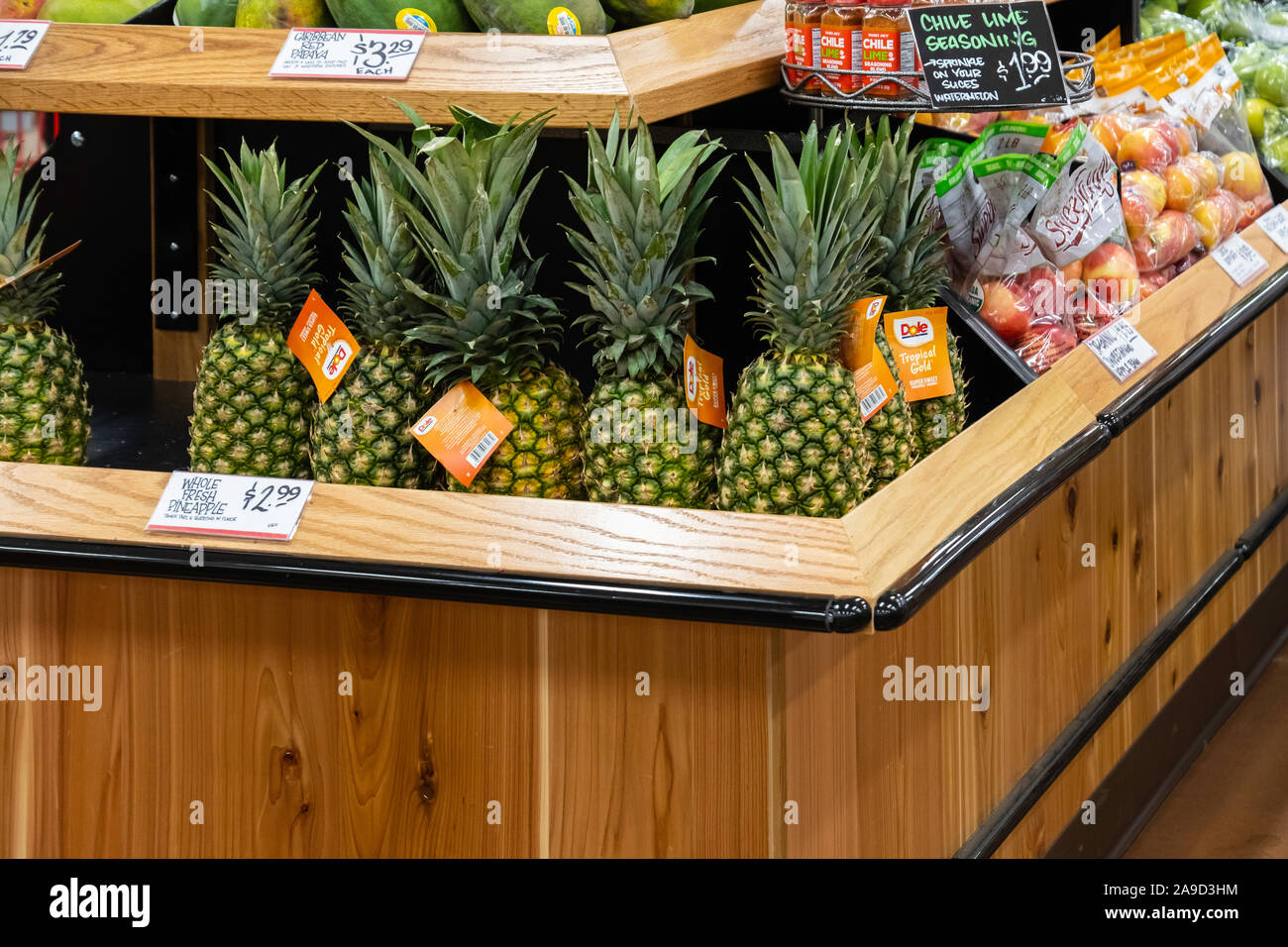 Display of organic fruit including pineapples in a Trader Joes market, Wichita, Kansas, USA. Stock Photo