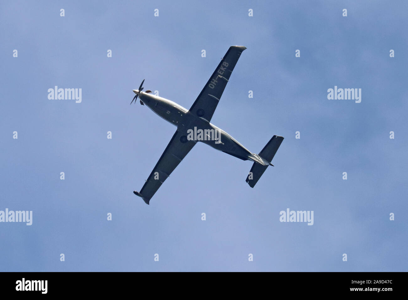 Pilatus PC-12/47E single engined light aircraft  OH-EKB flying overhead, set against a blue sky Stock Photo