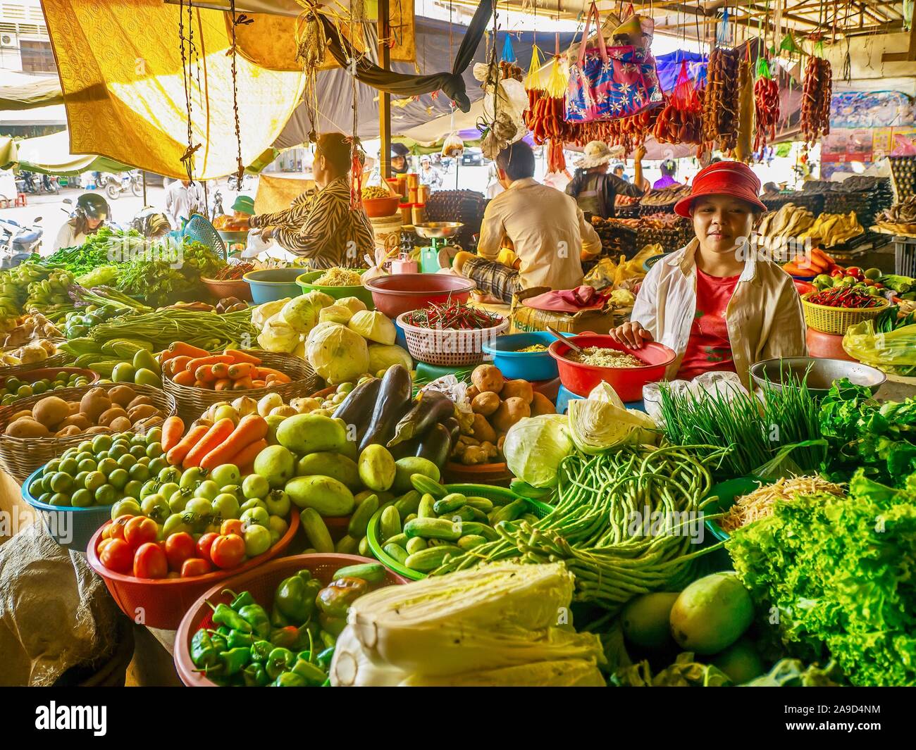 Showing a variety of fresh produce for sale at a local indoor public market, typical of southeast Asia. Stock Photo