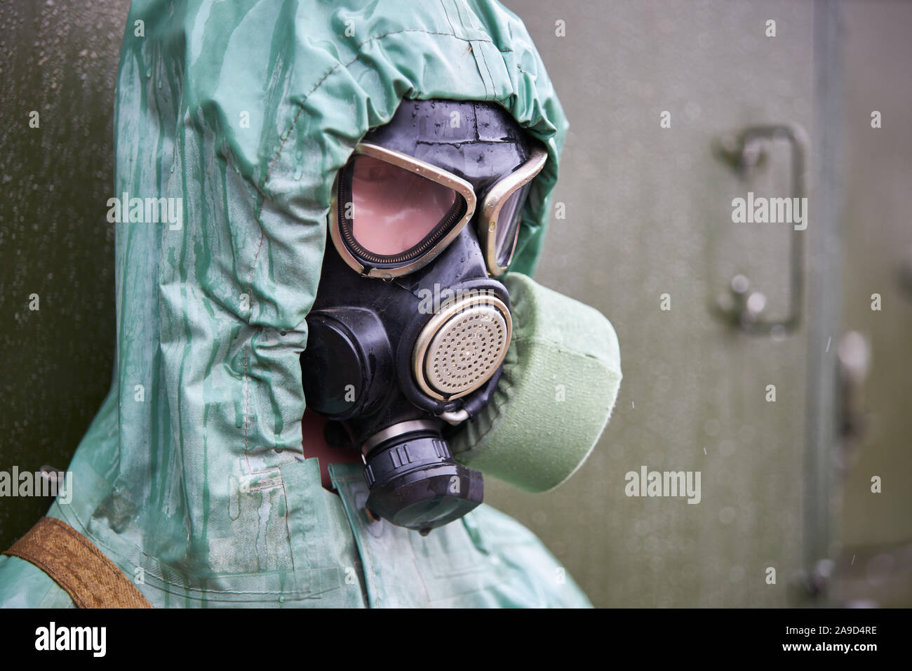 Mannequin dressed in green rubber chemical protection suit and black gas  mask, close-up Stock Photo - Alamy