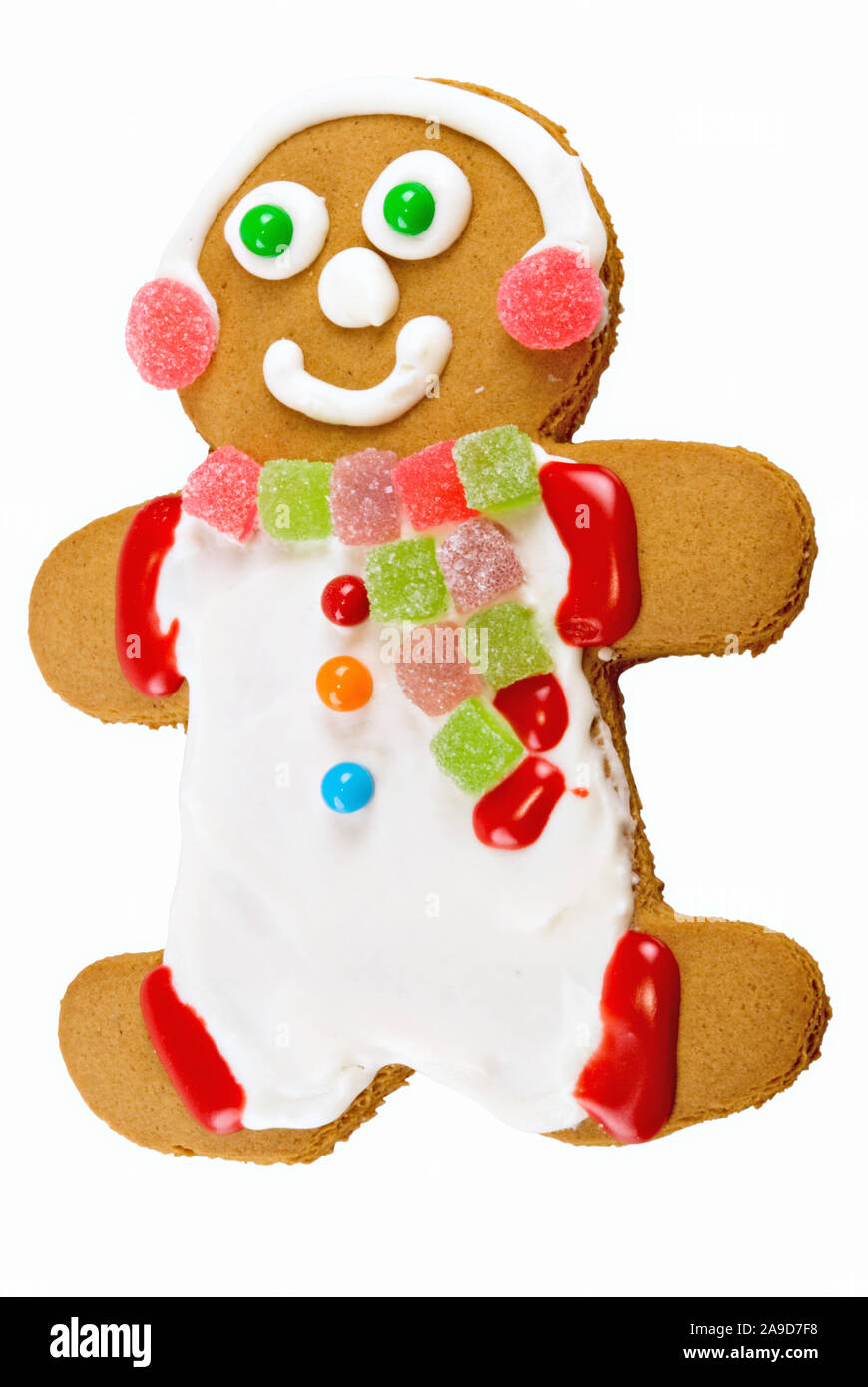 smiling gingerbread cookie man on an isolated white background. His clothing is made from frosting and candy. Stock Photo