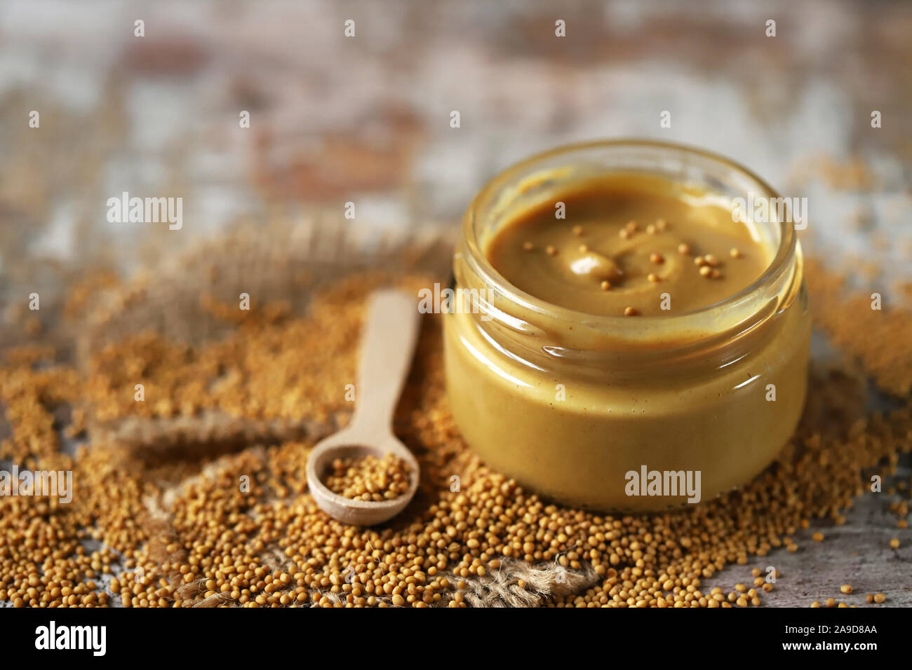 Natural mustard in a jar. Grains of mustard. Homemade mustard. Organic mustard. Selective focus. Macro. Stock Photo