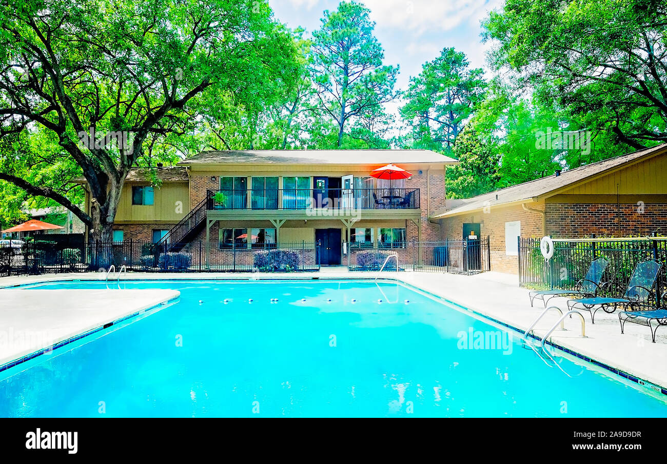 A built-in swimming pool is one of the amenities available to residents at Autumn Woods apartment homes, November 27, 2015, in Mobile, Alabama. Stock Photo