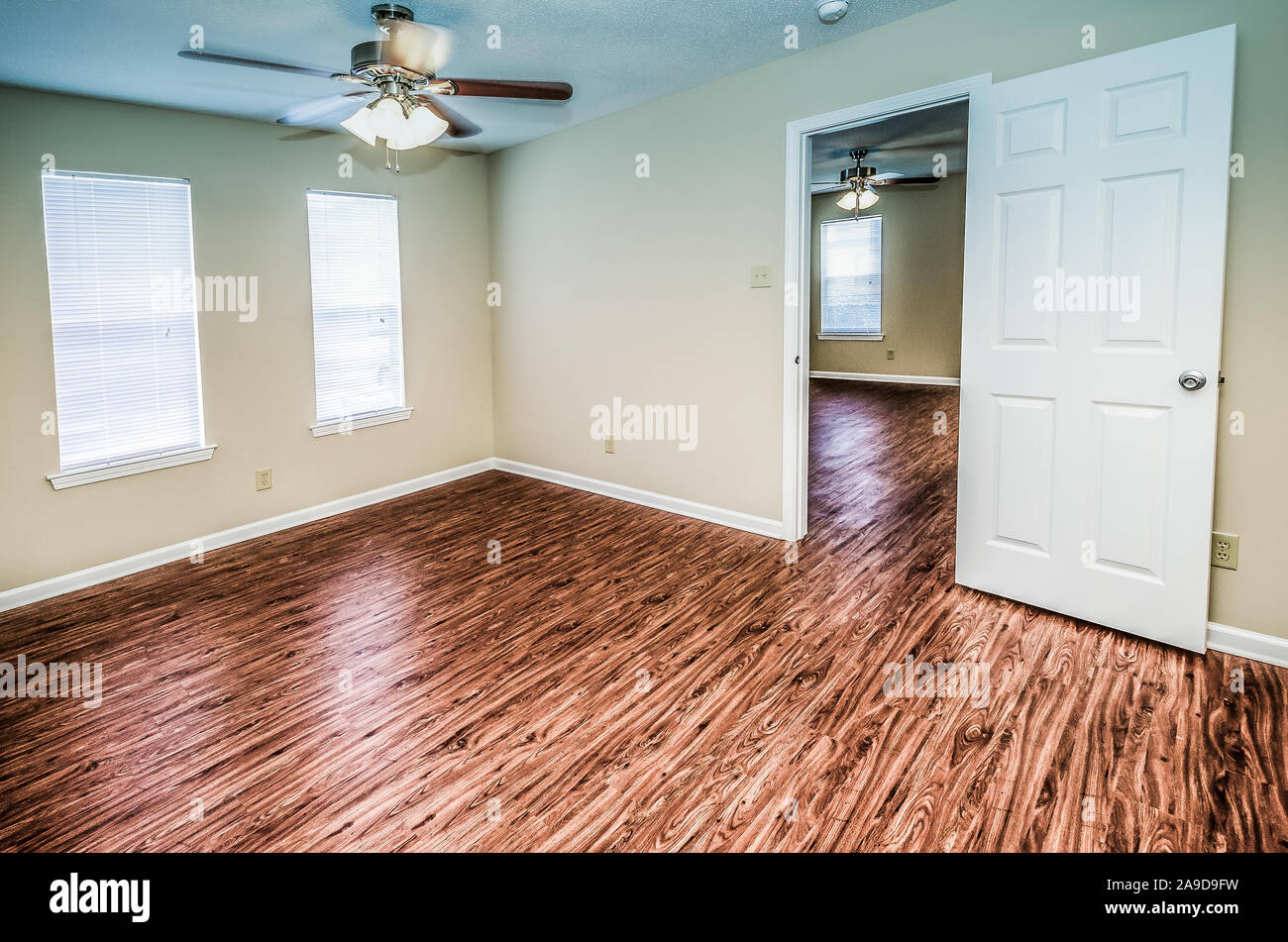 Empty bedrooms feature hardwood floors and lots of window light at Autumn Woods apartment homes in Mobile, Alabama. Stock Photo