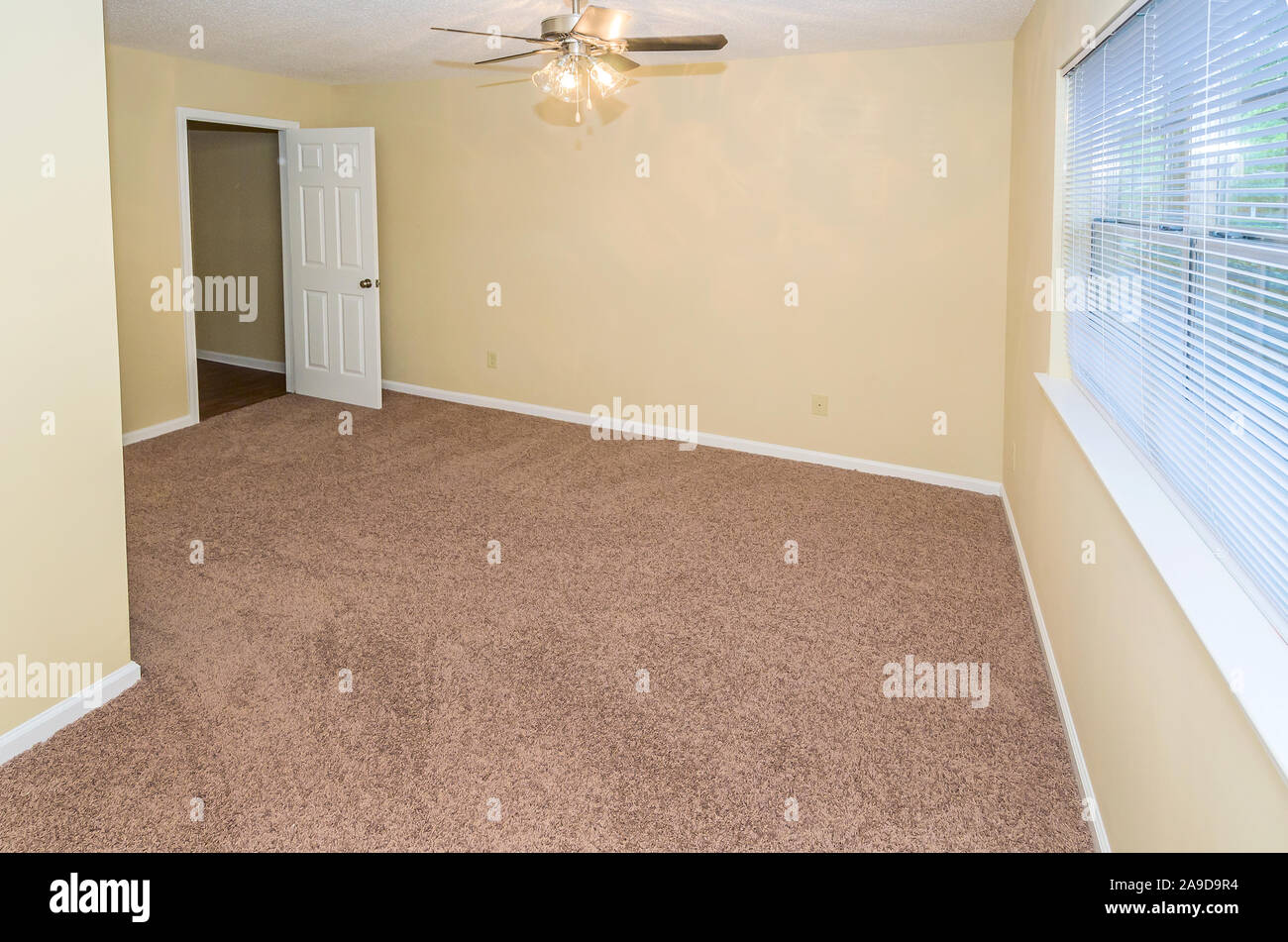 An unfurnished, carpeted bedroom is pictured at Autumn Woods apartment homes in Mobile, Alabama. Stock Photo