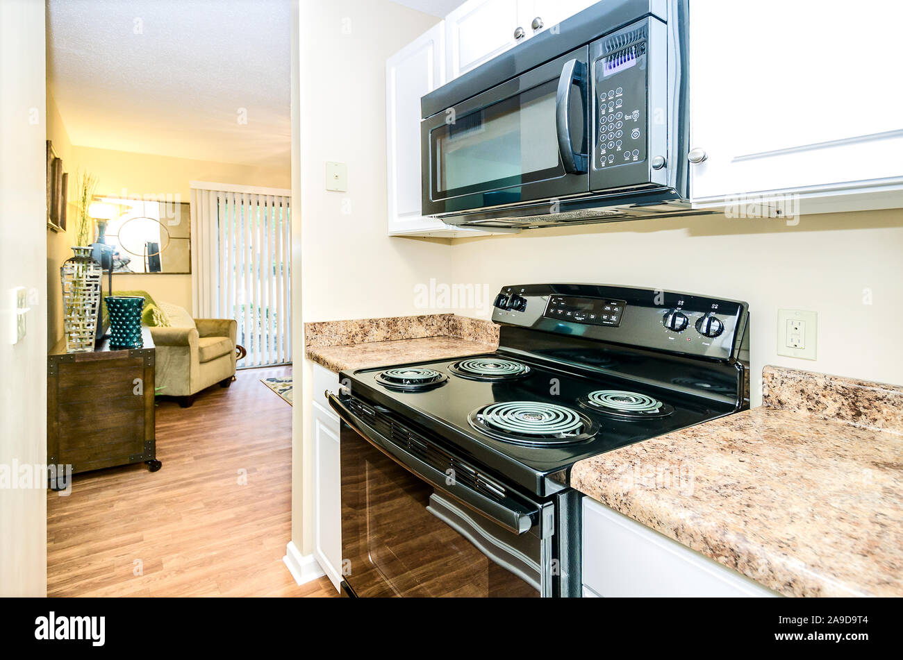 The kitchen features an electric stove at Autumn Woods apartment homes in Mobile, Alabama. The