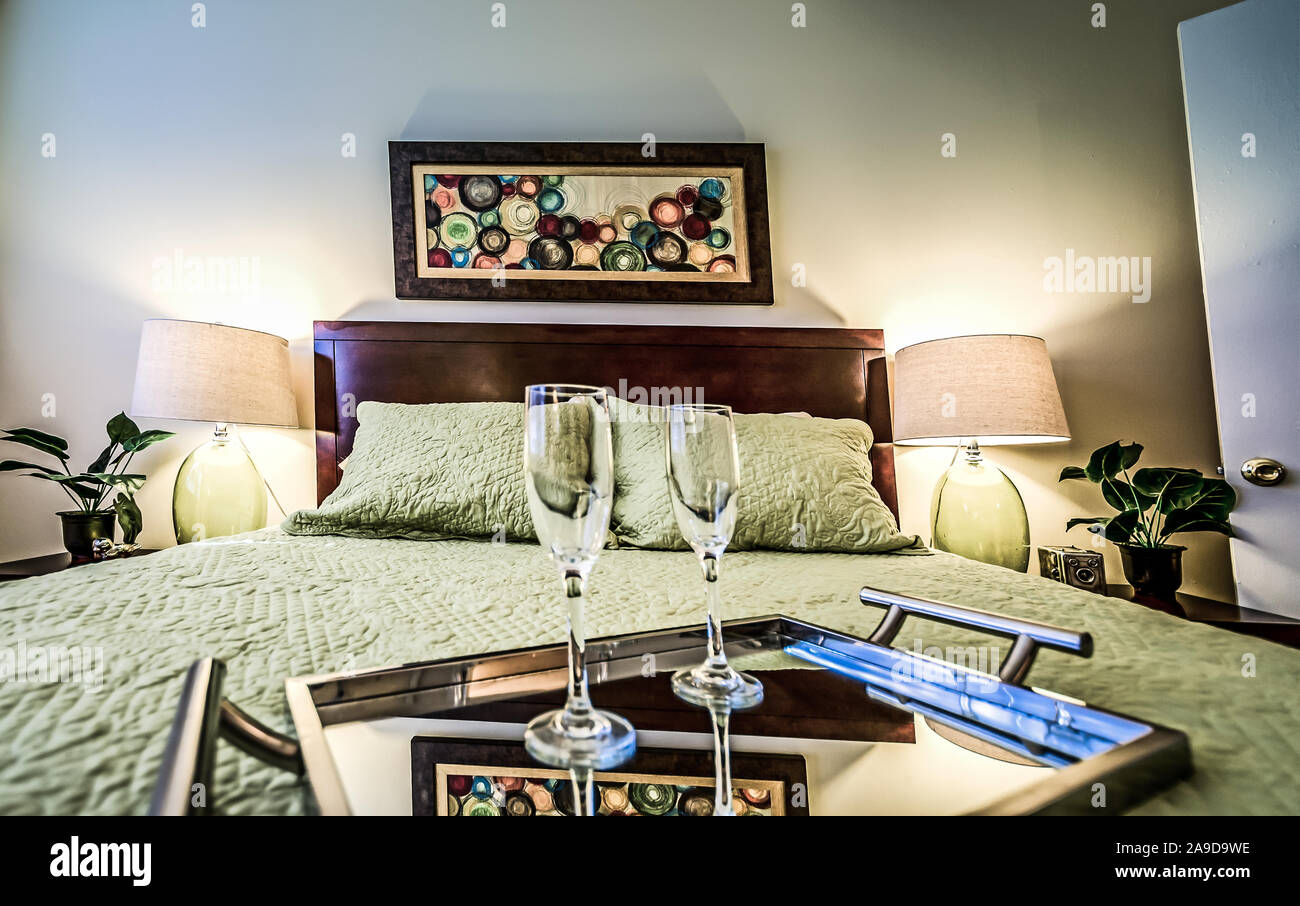 A tray with champagne flutes sits on a bed in a bedroom at Autumn Woods