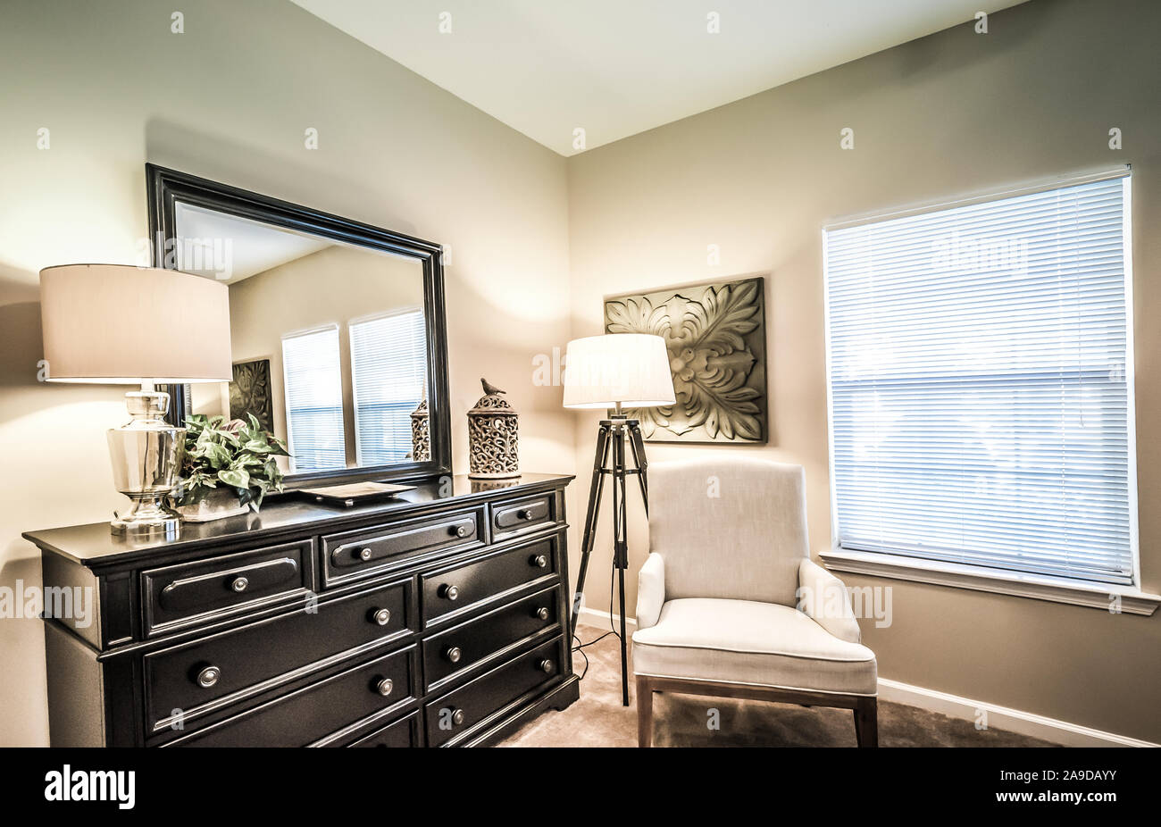 A bedroom dresser and mirror is pictured at Cypress Cove Apartment