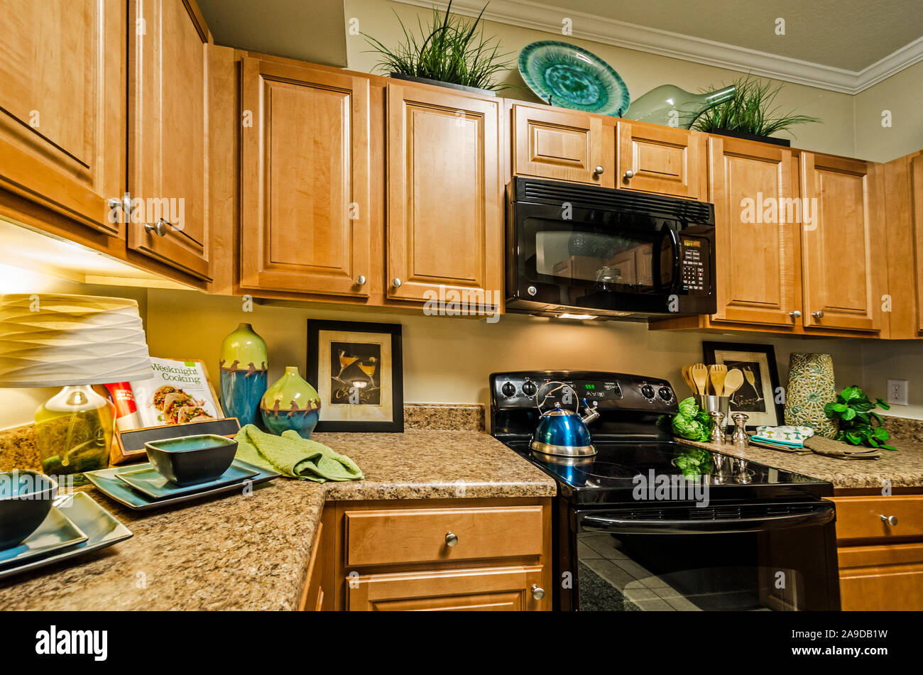 A Kitchen Features Granite Countertops Wooden Cabinets A Glass