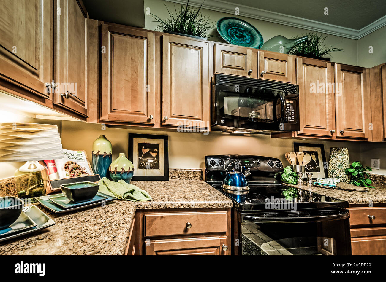 A Kitchen Features Granite Countertops Wooden Cabinets A Glass
