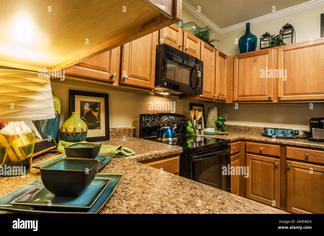 A kitchen features granite countertops, wooden a glass
