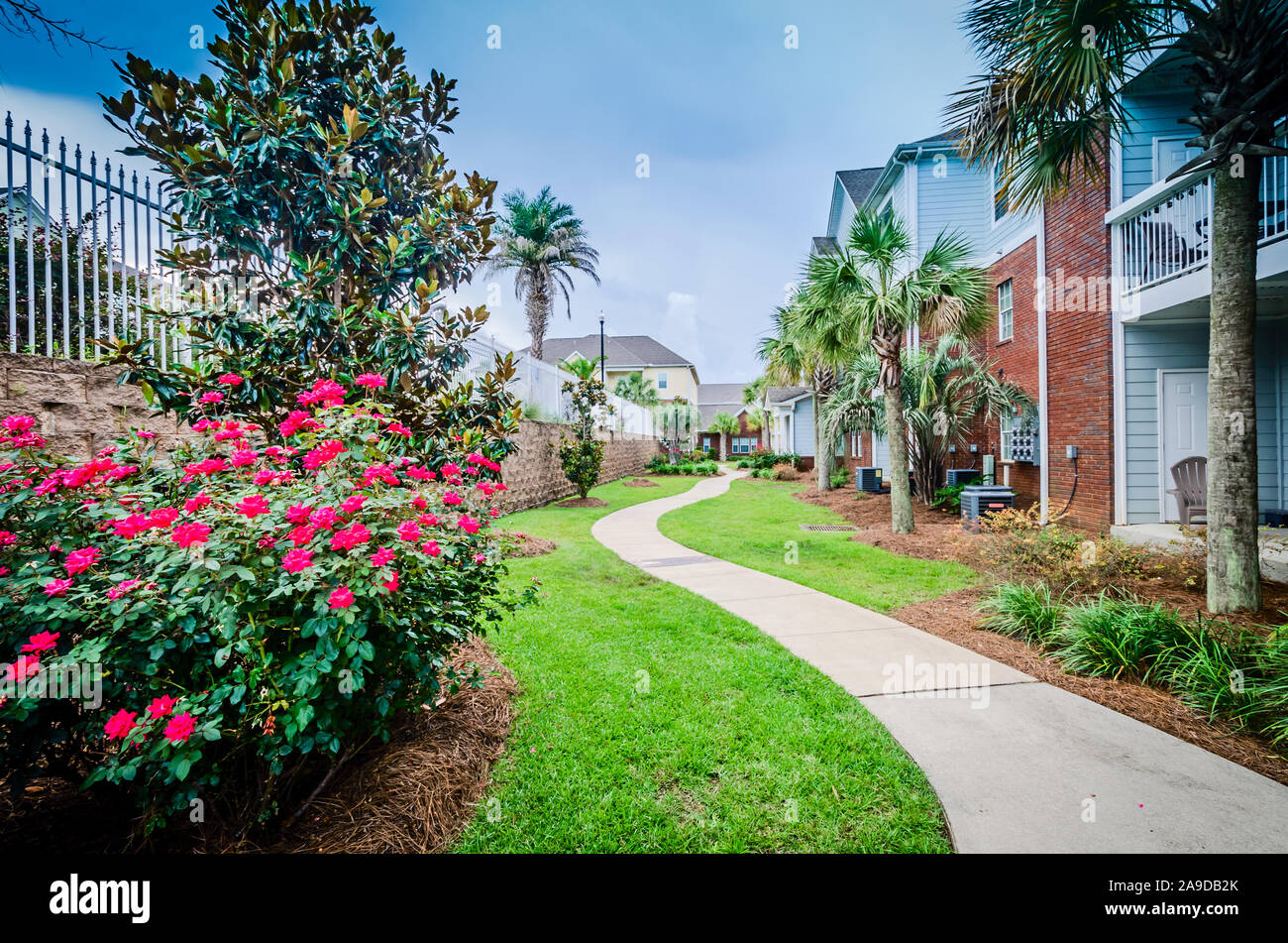 A curving sidewalk leads residents between the swimming pool and
