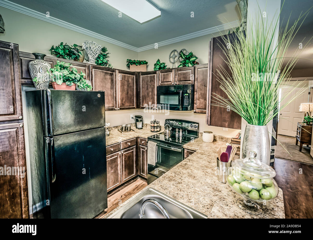 The kitchen features granite countertops, electric appliances, and wood