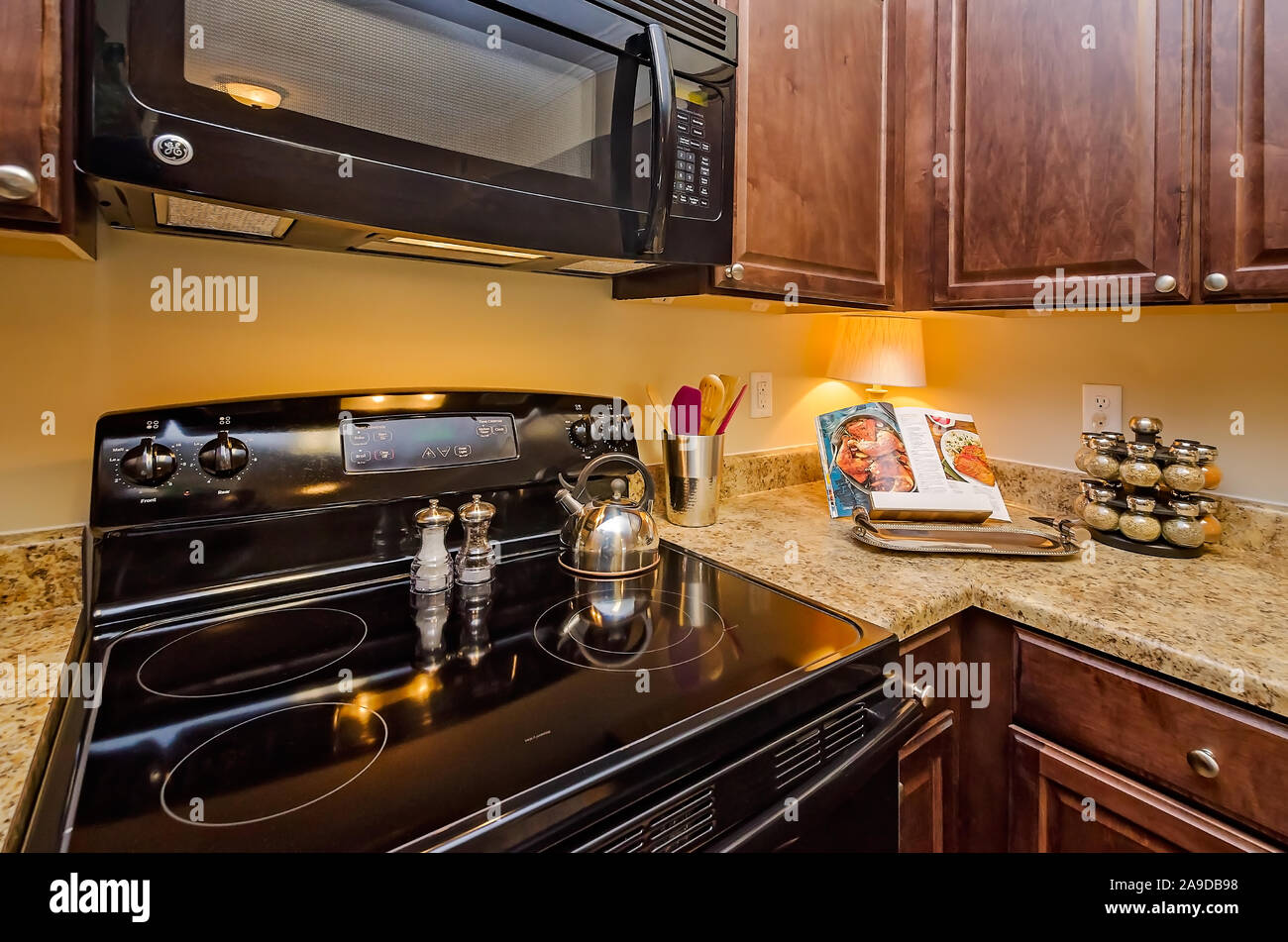 A Kitchen Features Granite Countertops Wooden Cabinets A Glass