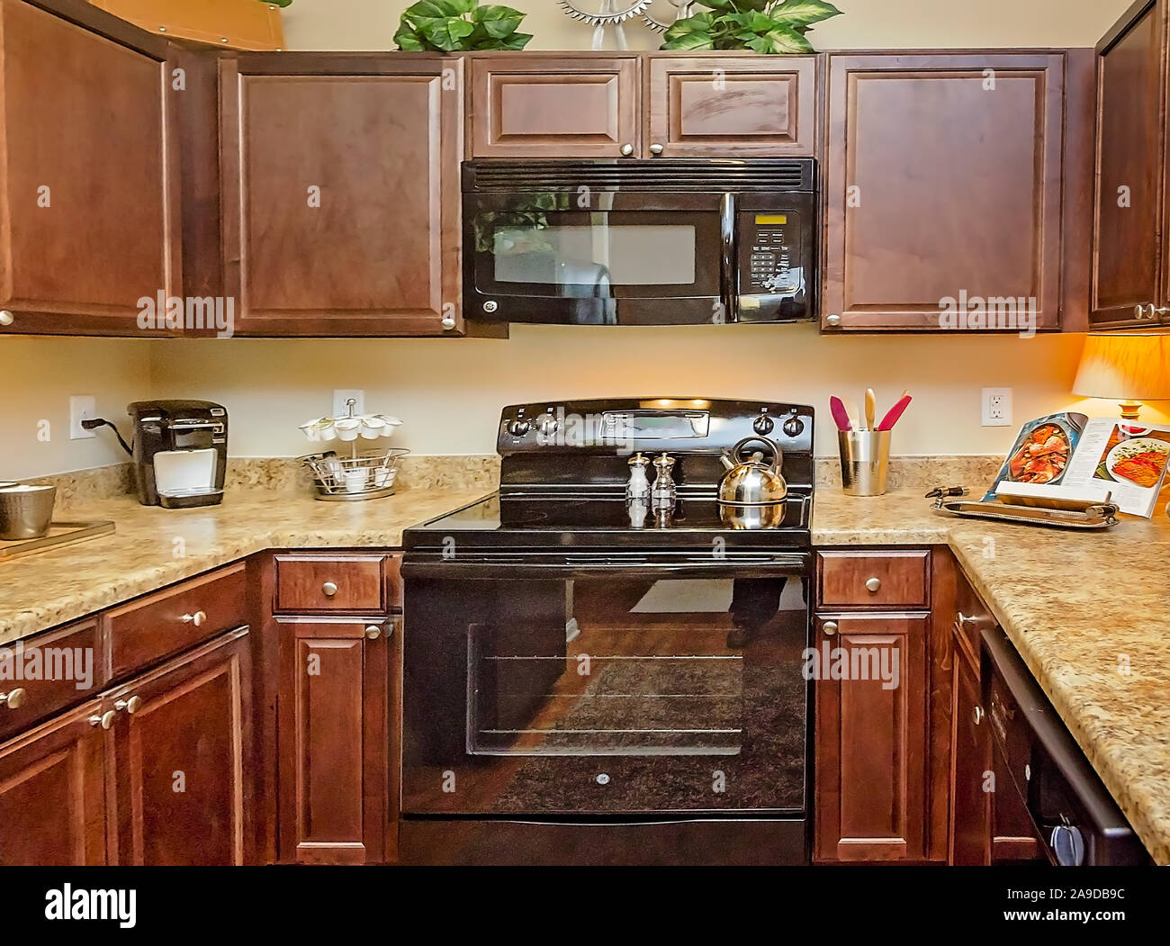 A kitchen features granite countertops, wooden a glass