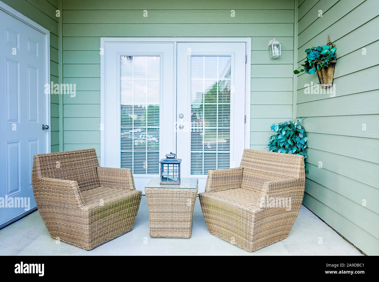 Wicker chairs make a cozy seating arrangement on a patio at Cypress
