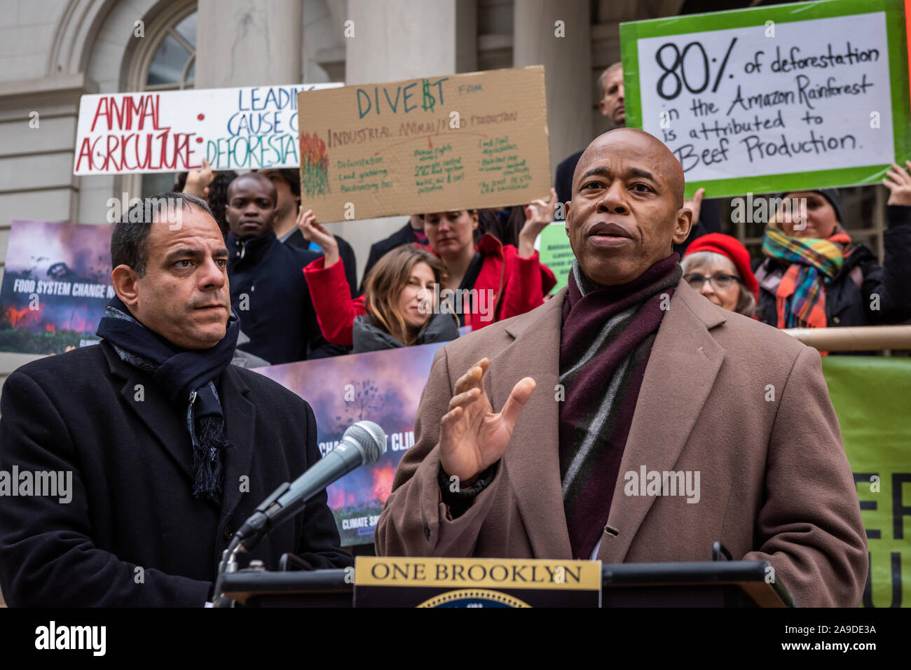 New York, USA. 14th Nov, 2019. (L-R) New York City Council Member Costa Constantinides and Eric Adams announce a resolution calling for ban on business with companies tied to the Amazon Wildfires on the steps of New York City Hall on November 14, 2019. An annual 5% increased demand for beef has prompted South American ranchers to burn swaths of the historic rainforest, an asset in the fight against climate change, which have gone out of control. (Photo by Gabriele Holtermann-Gorden/Pacific Press) Credit: Pacific Press Agency/Alamy Live News Stock Photo