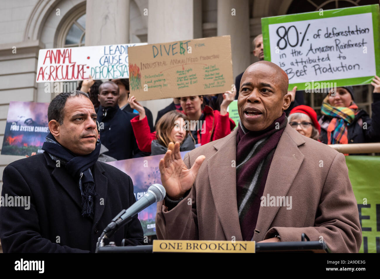 New York, USA. 14th Nov, 2019. (L-R) New York City Council Member Costa Constantinides and Eric Adams announce a resolution calling for ban on business with companies tied to the Amazon Wildfires on the steps of New York City Hall on November 14, 2019. An annual 5% increased demand for beef has prompted South American ranchers to burn swaths of the historic rainforest, an asset in the fight against climate change, which have gone out of control. (Photo by Gabriele Holtermann-Gorden/Pacific Press) Credit: Pacific Press Agency/Alamy Live News Stock Photo
