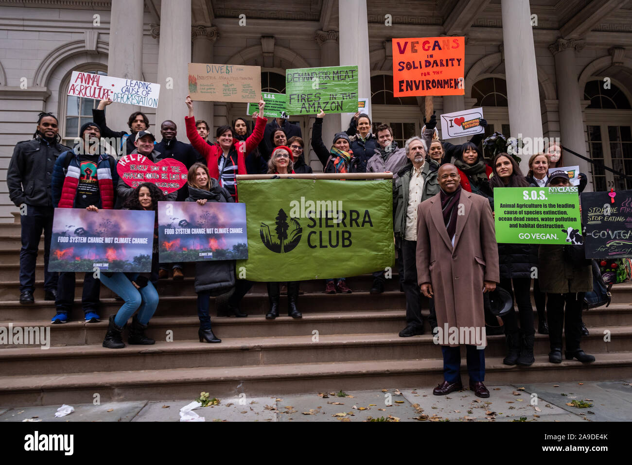 New York, USA. 14th Nov, 2019. Brooklyn Borough President Eric Adams with environmental activist on the steps of City Hall after the announcement of a resolution calling for ban on business with companies tied to the Amazon Wildfires in New York City on November 14, 2019. An annual 5% increased demand for beef has prompted South American ranchers to burn swaths of the historic rainforest, an asset in the fight against climate change, which have gone out of control. (Photo by Gabriele Holtermann-Gorden/Pacific Press) Credit: Pacific Press Agency/Alamy Live News Stock Photo