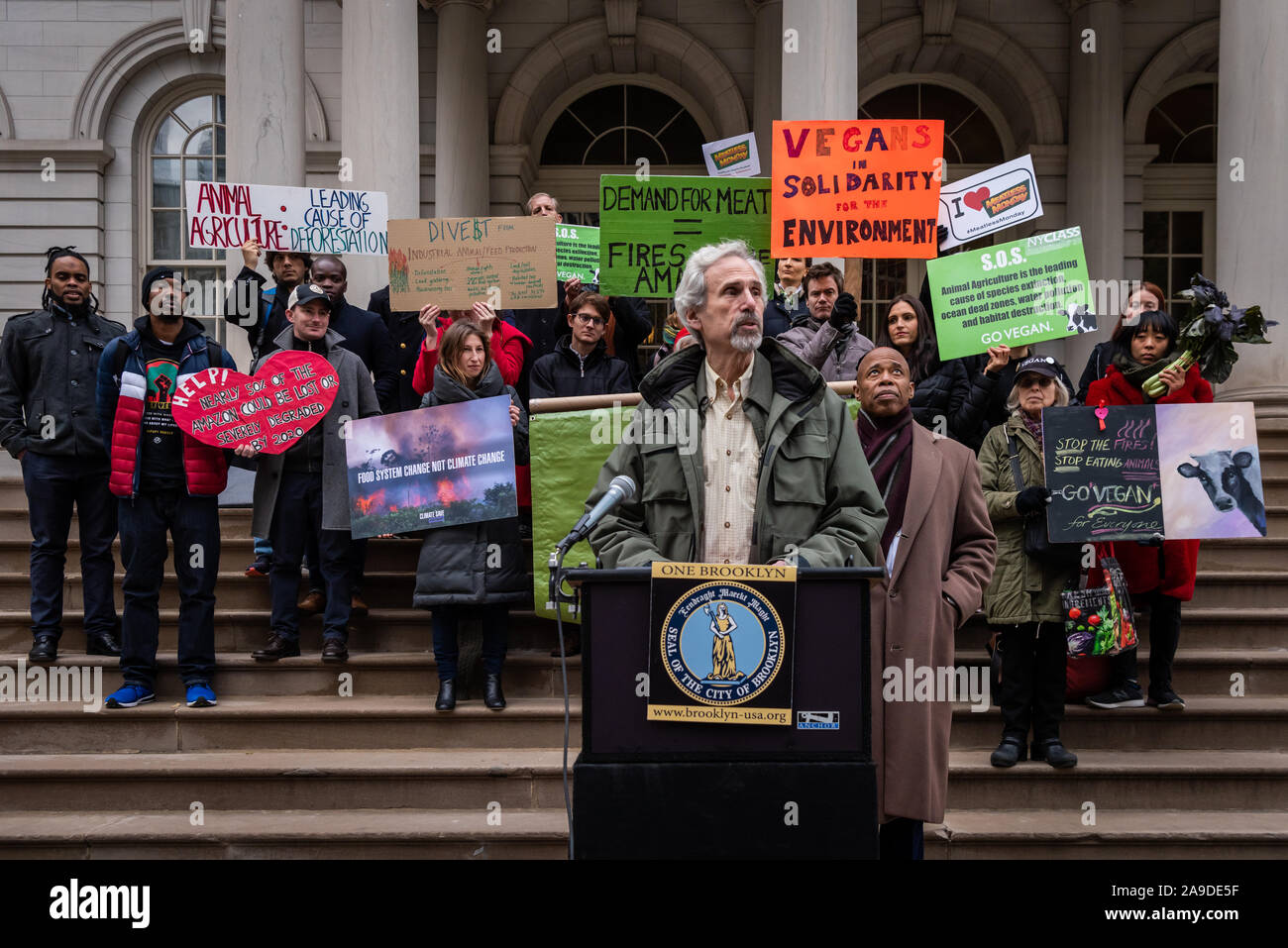 New York, USA. 14th Nov, 2019. Carl Arnold of the Sierra Club speaks at the press conference of Brooklyn Borough President Eric Adams and New York City Council Member Costa Constantinides who announced a resolution calling for ban on business with companies tied to the Amazon Wildfires on the steps of New York City Hall on November 14, 2019. An annual 5% increased demand for beef has prompted South American ranchers to burn swaths of the historic rainforest, an asset in the fight against climate change, which have gone out of control. (Photo by Gabriele Holtermann-Gorden/Pacific Press) Stock Photo