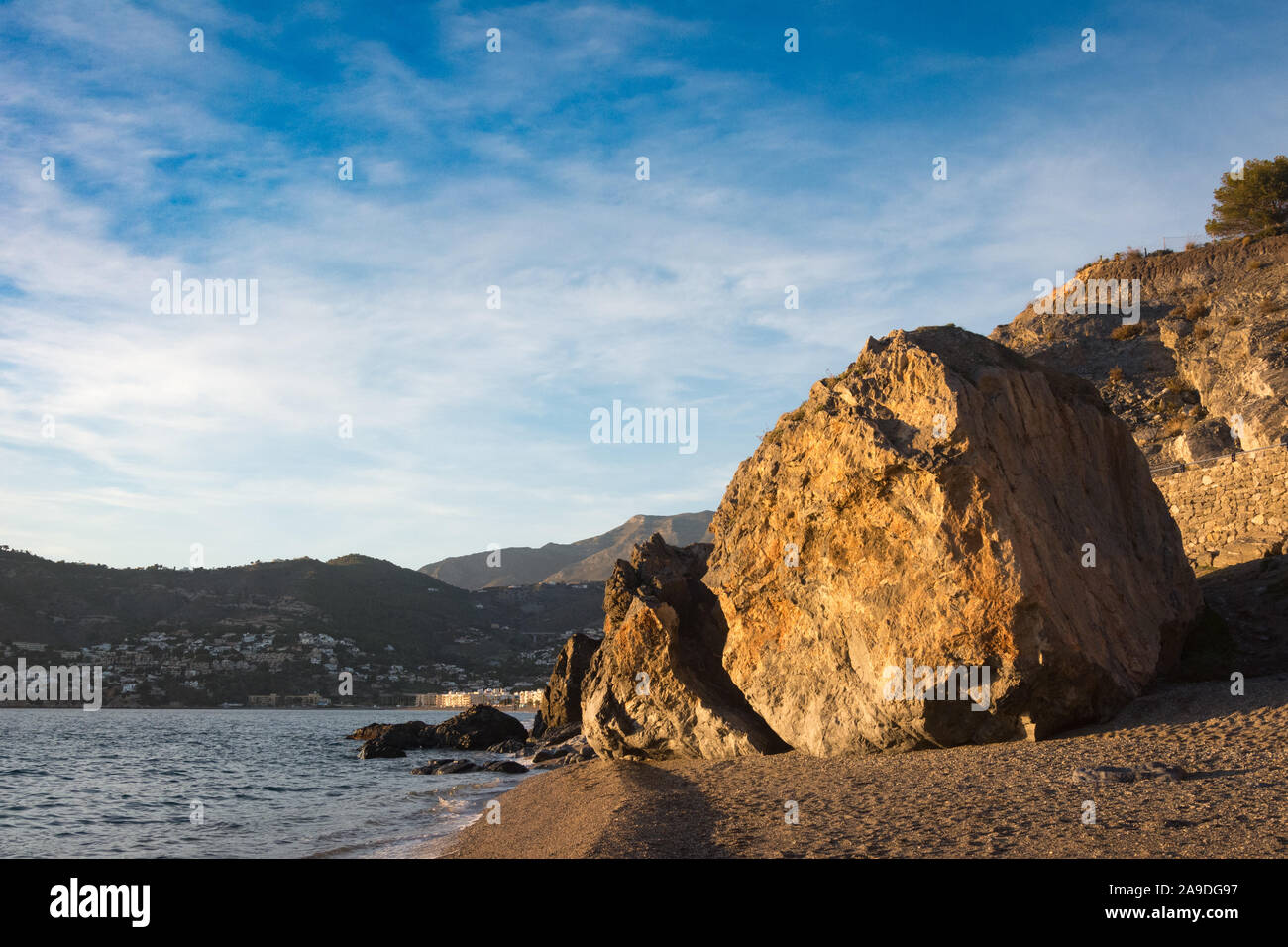A huge boulder lying on the beach at La Herradura, Andalusia, Spain Stock Photo