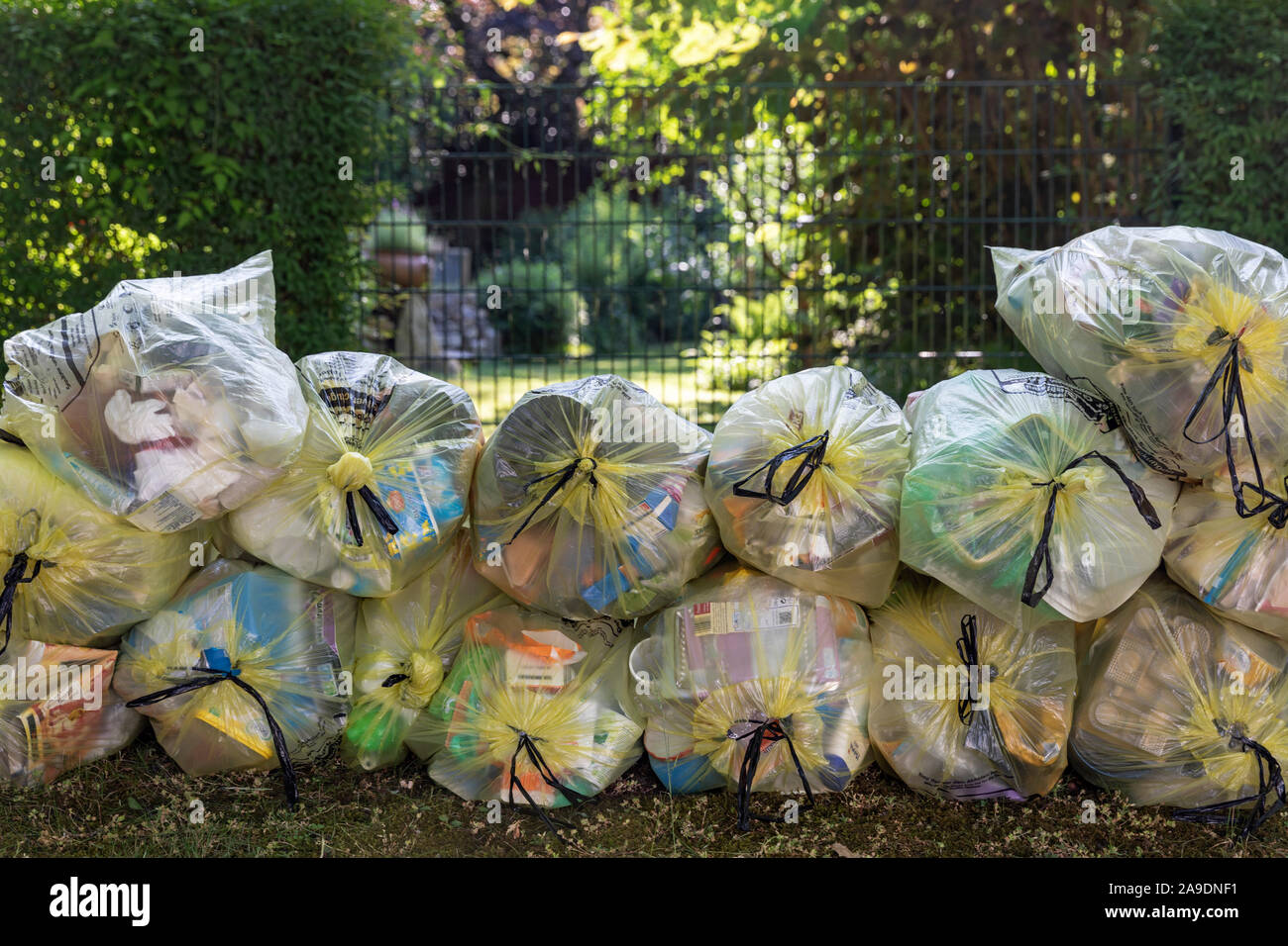 Stacked yellow sacks on the sidewalk in Wilhelmshaven, Lower Saxony, Stock Photo