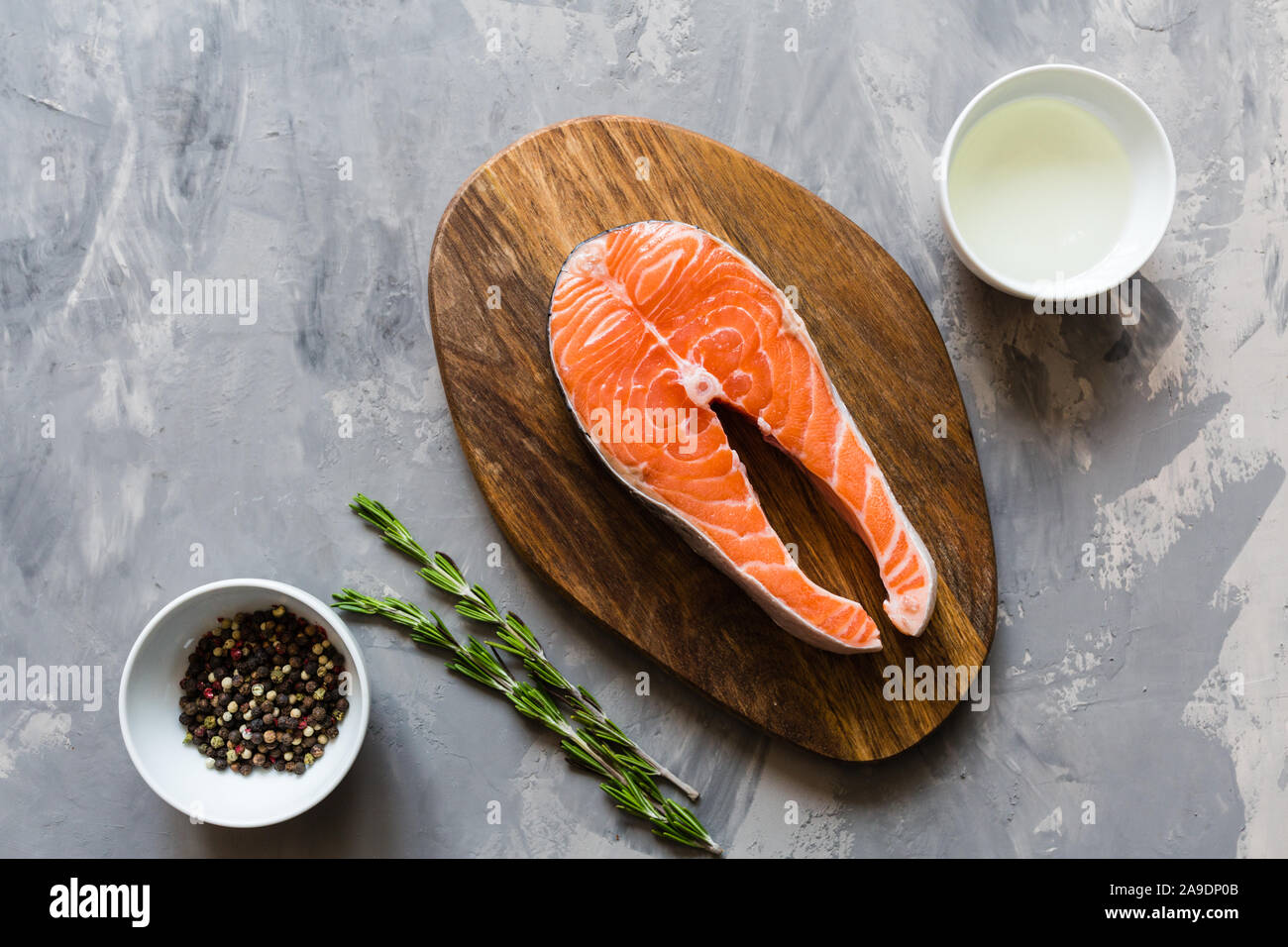 Fresh raw salmon fish steak with spices on dark stone background ...