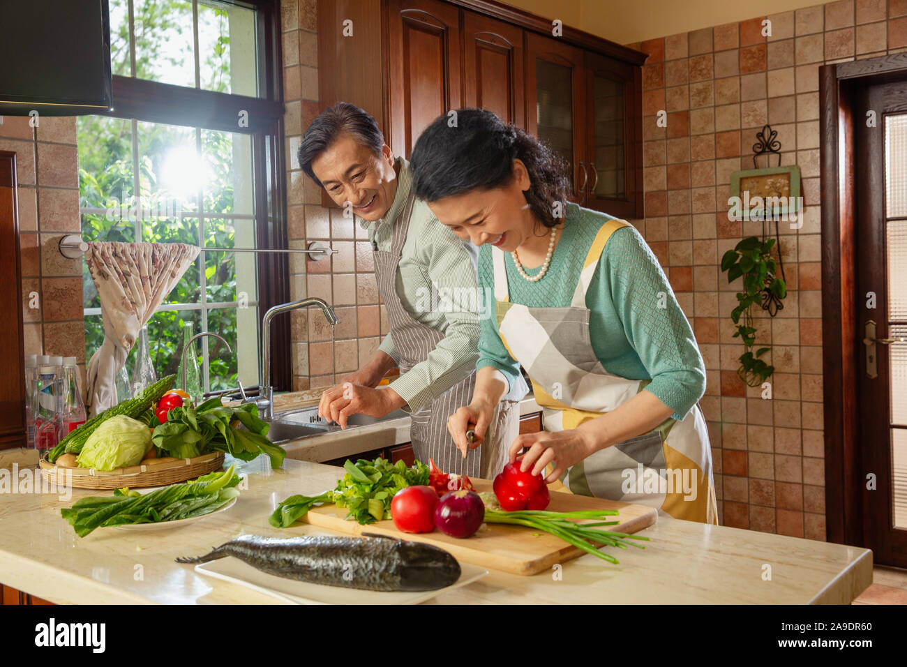 Elderly couple is cooking in the kitchen Stock Photo