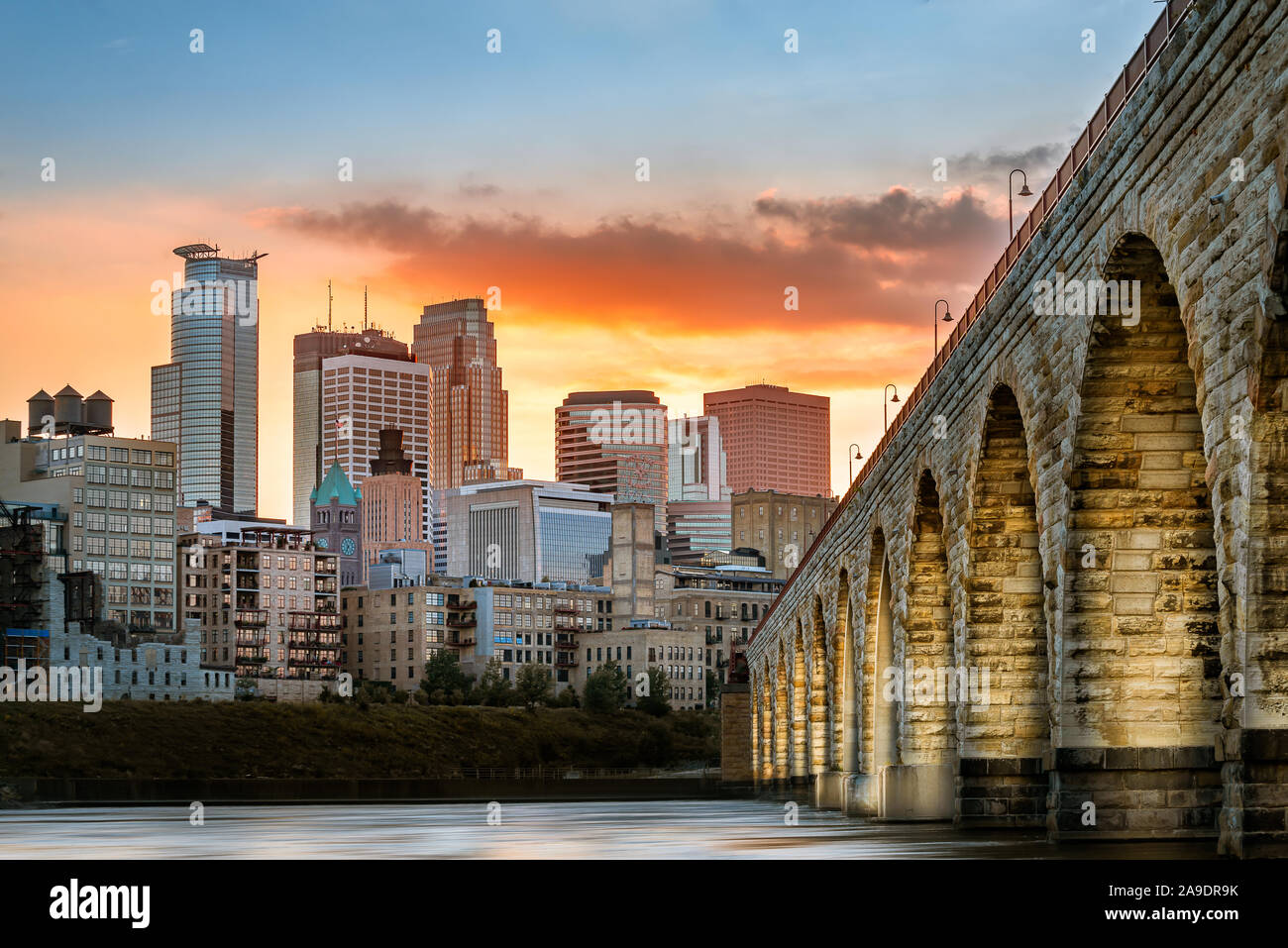 Stone Arch Bridge lights in Minneapolis at sunset Stock Photo
