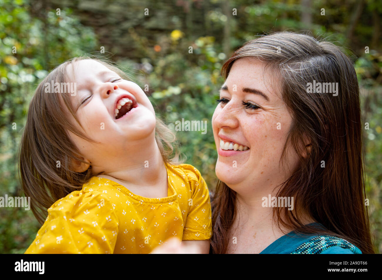 Mother and daughter being silly and laughing together on a hike Stock Photo