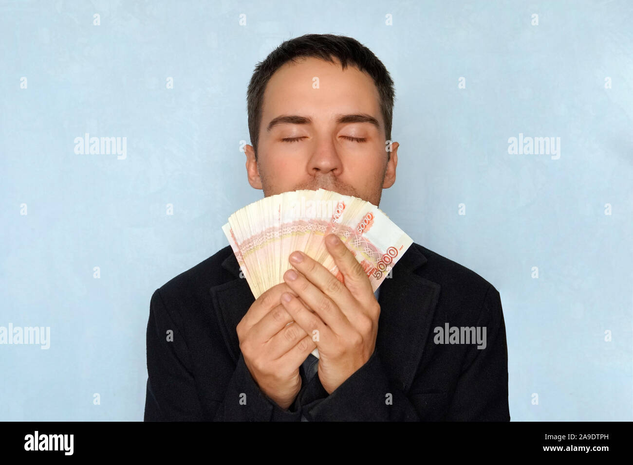 Successful business man smelling money hi-res stock photography 