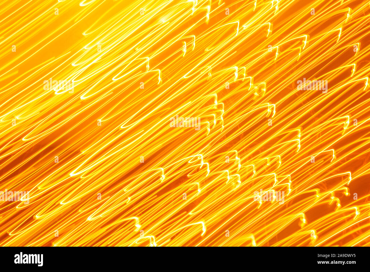 Futuristic blurred lights holiday monochrome background in yellow. Horizontal, soft focus Stock Photo