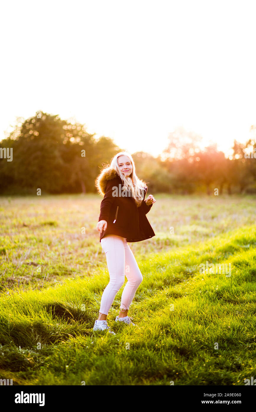 Girl dancing in the sunset during a fall day in germany Stock Photo