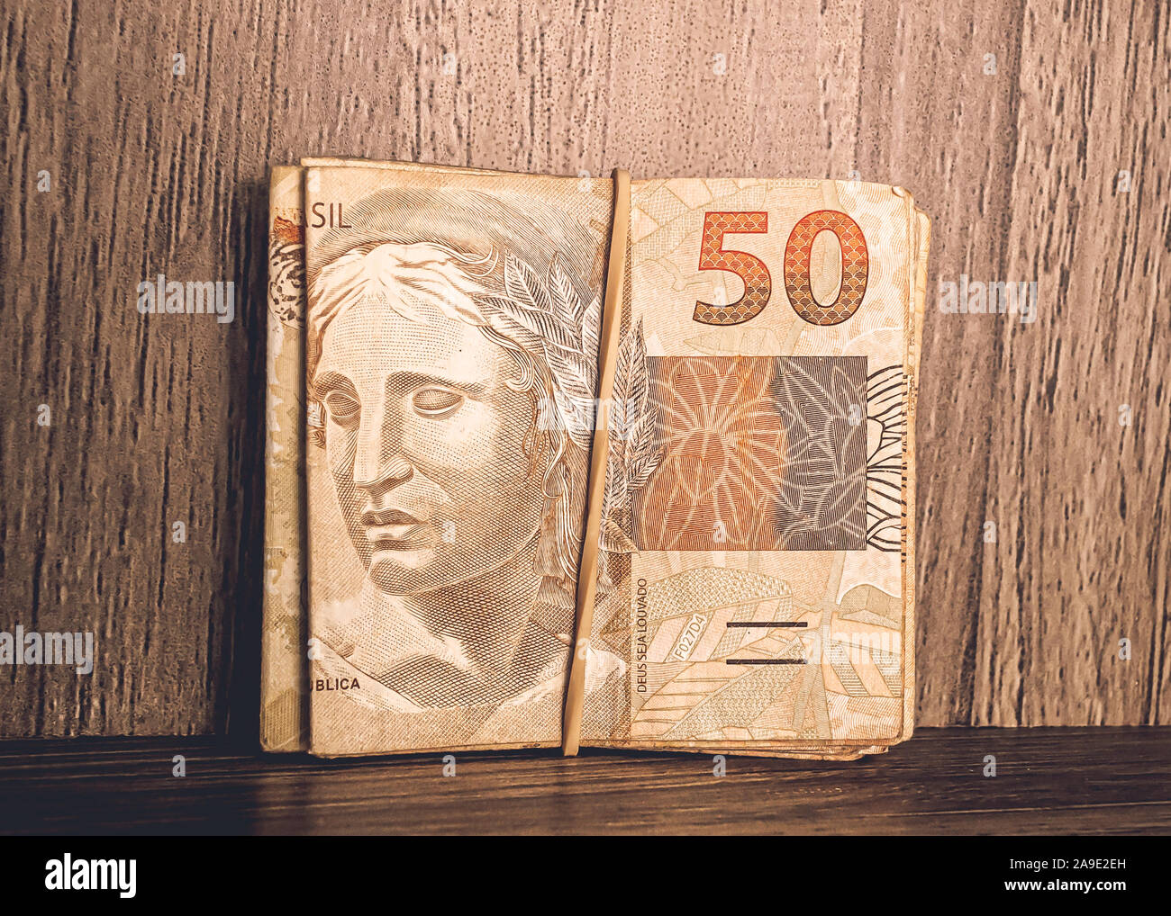 Premium Photo  Brazillian money, man holding 50 reais notes