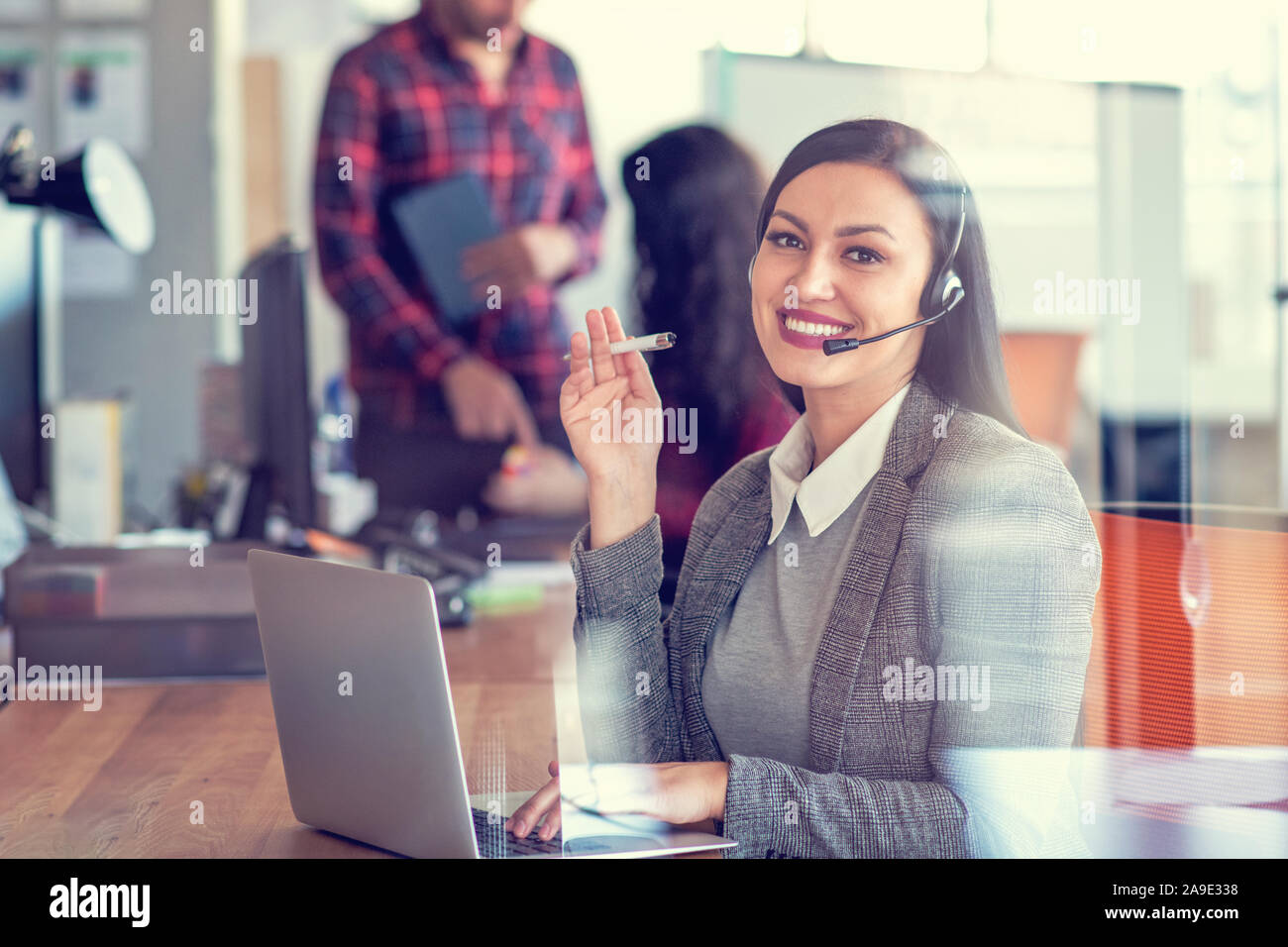 Beautiful call center agent browsing the internet on her computer Stock Photo