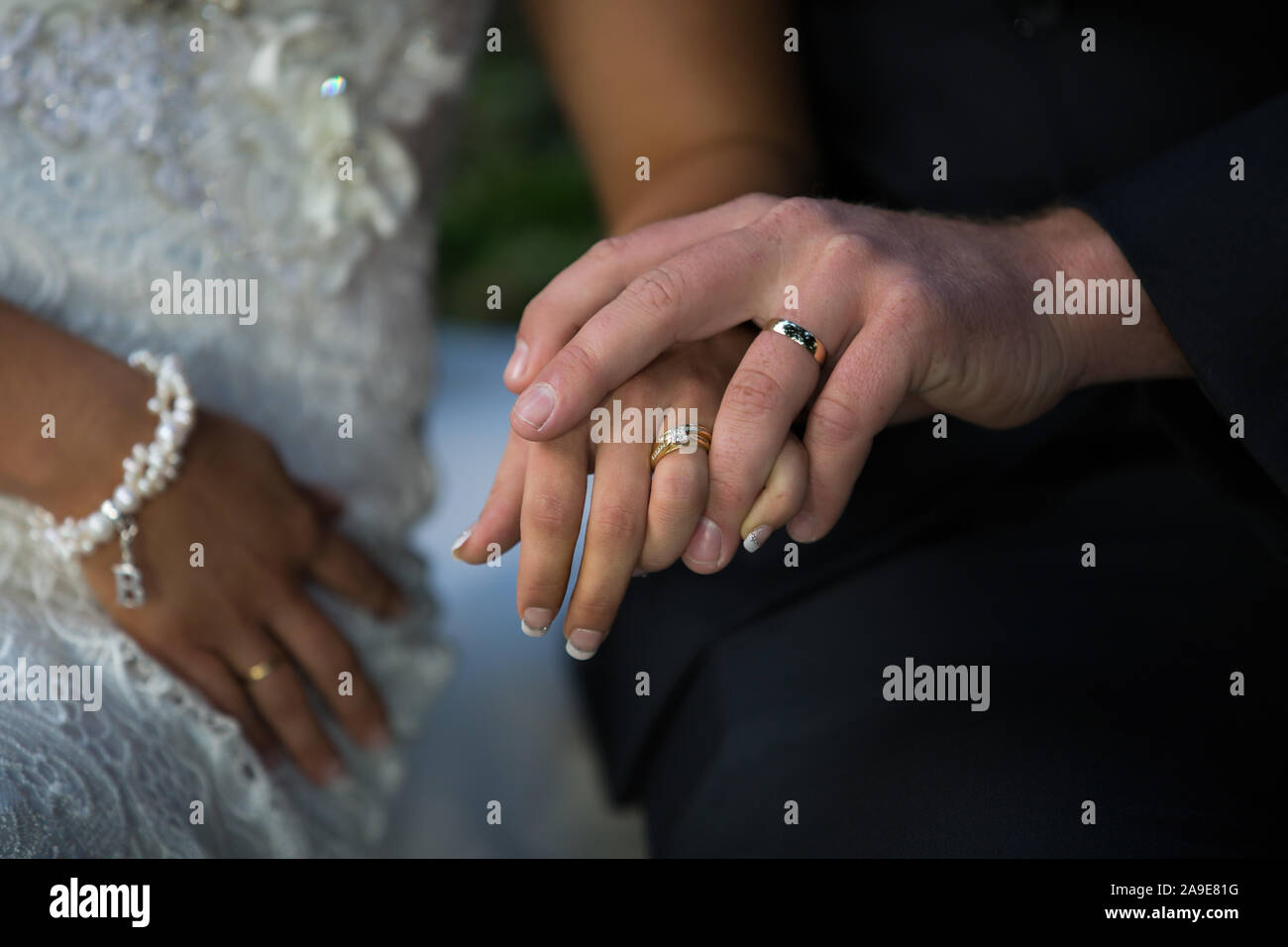 Bride And Groom Holding Hands Showing Off Their Wedding Rings Stock Photo Alamy