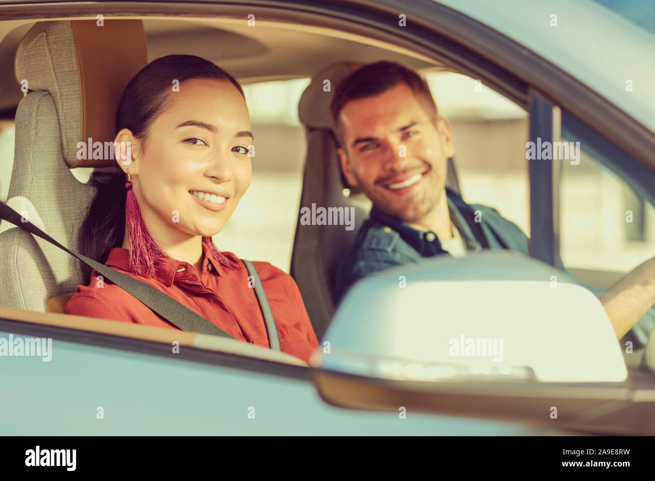 Delighted young people sitting in their auto Stock Photo