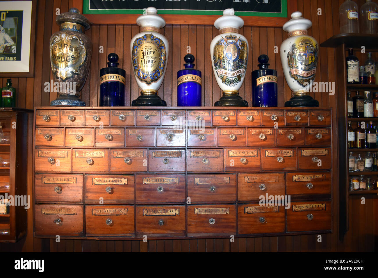 A ancient set of timber drawers set in an replica of an apothecary shop Stock Photo