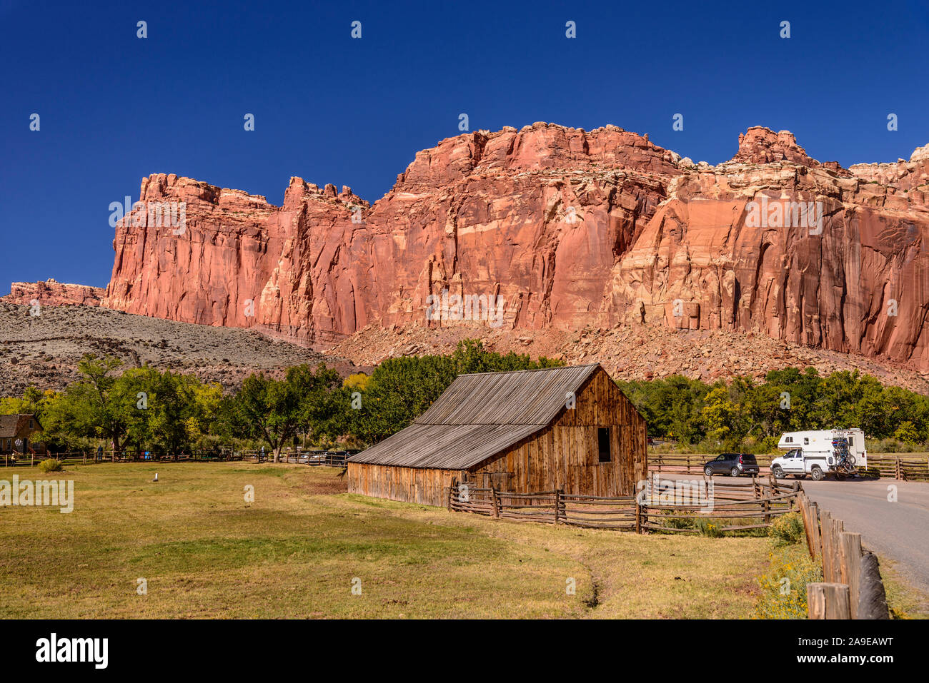 The USA, Utah, Wayne County, Torrey, Capitol Reef Nationwide park, Fremont River Valley, Fruita Historic District, Gifford Homestead with Fruita Cliff Stock Photo