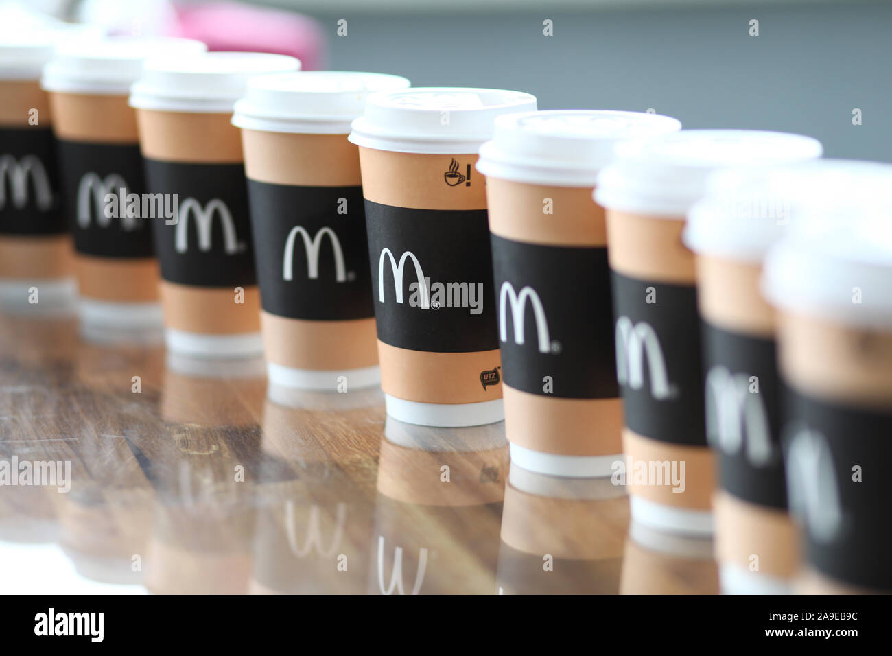 Pile of Mcdonald's paper cups standing one in line at table closeup ...