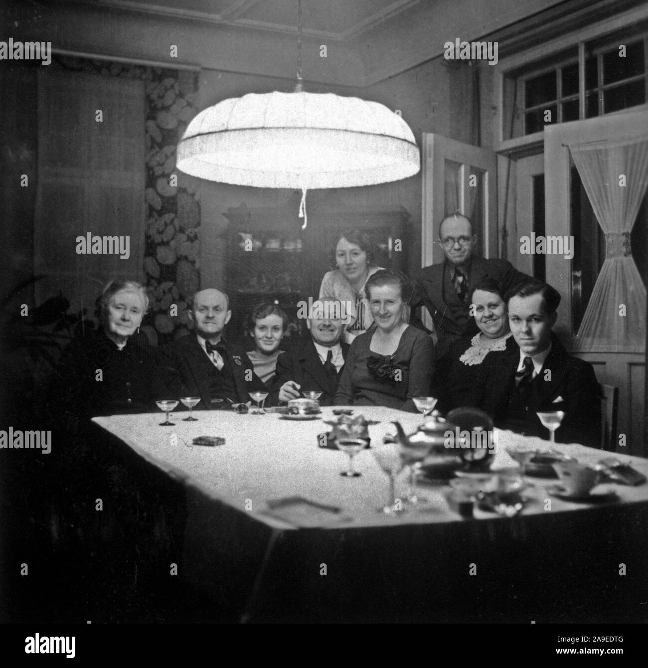 Eva Braun Collection (Album 2) - Family sitting for group portrait at table in what appears to be a dining room Stock Photo