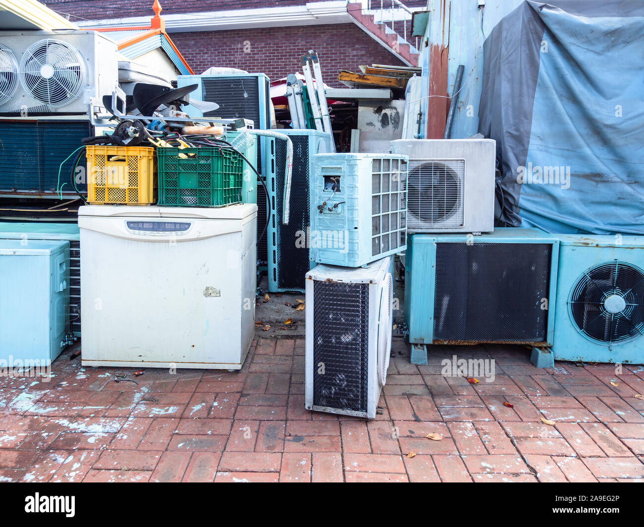 many old air conditioners and refrigerators on street near repair shop in Sokcho city, South Korea Stock Photo