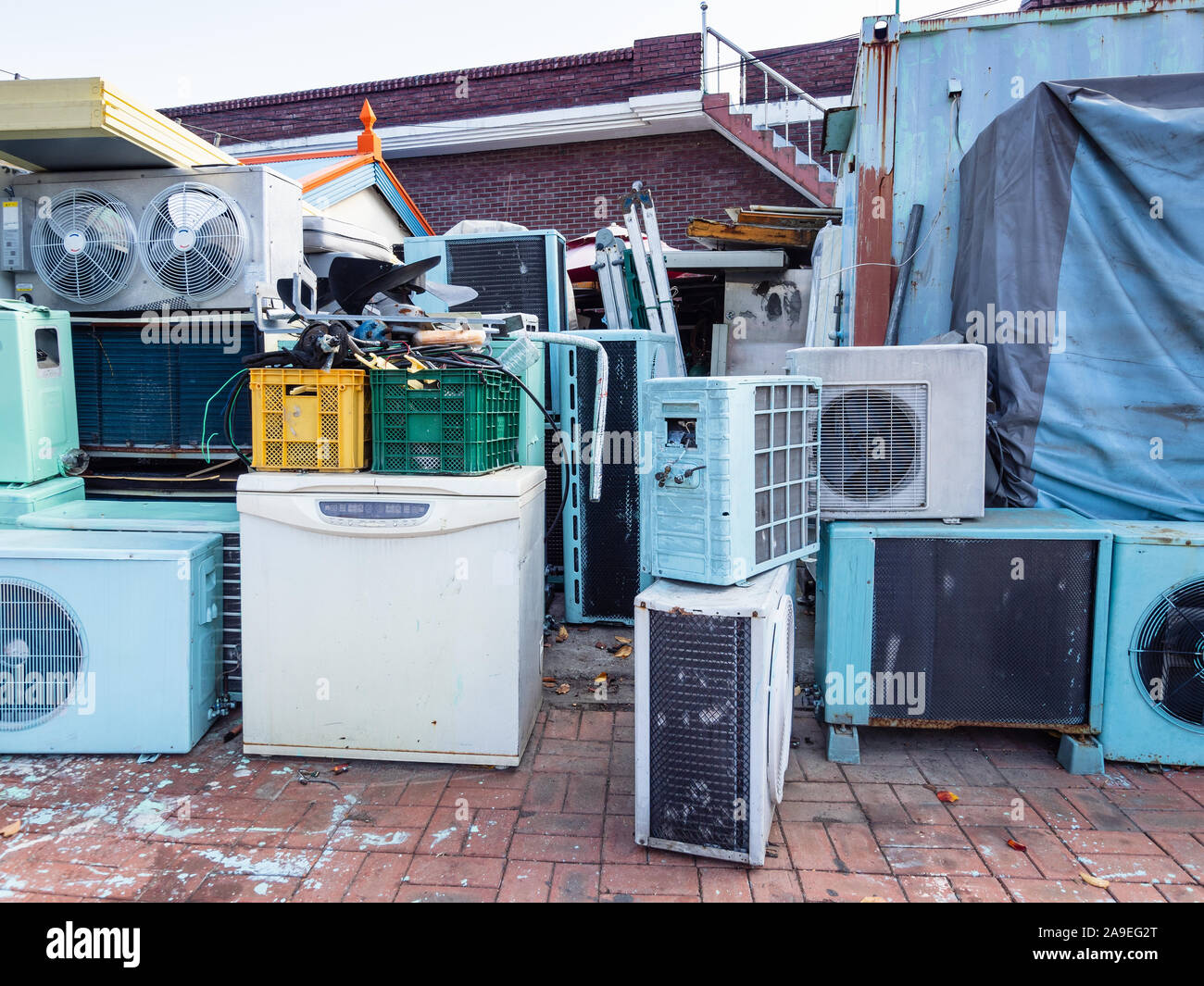 many used air conditioners and fridges on street near repair shop in Sokcho city, South Korea Stock Photo