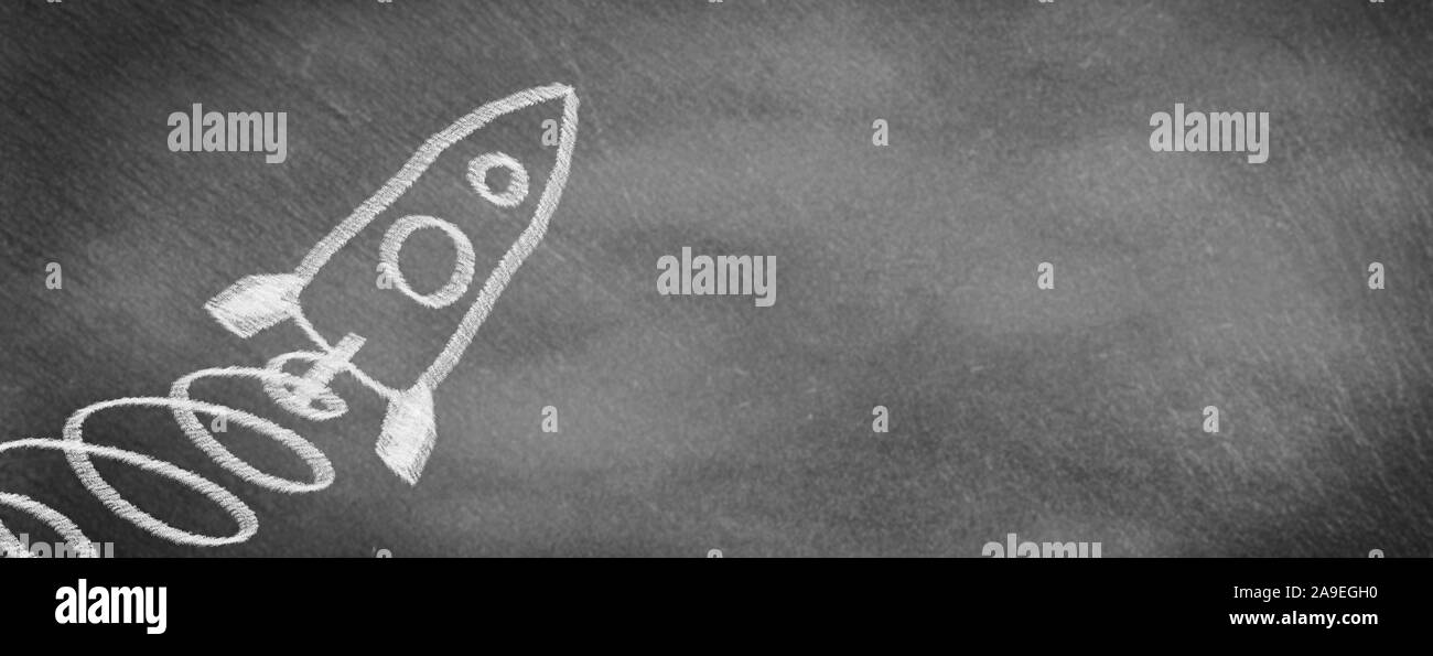 Drawn rocket starting on slate Stock Photo