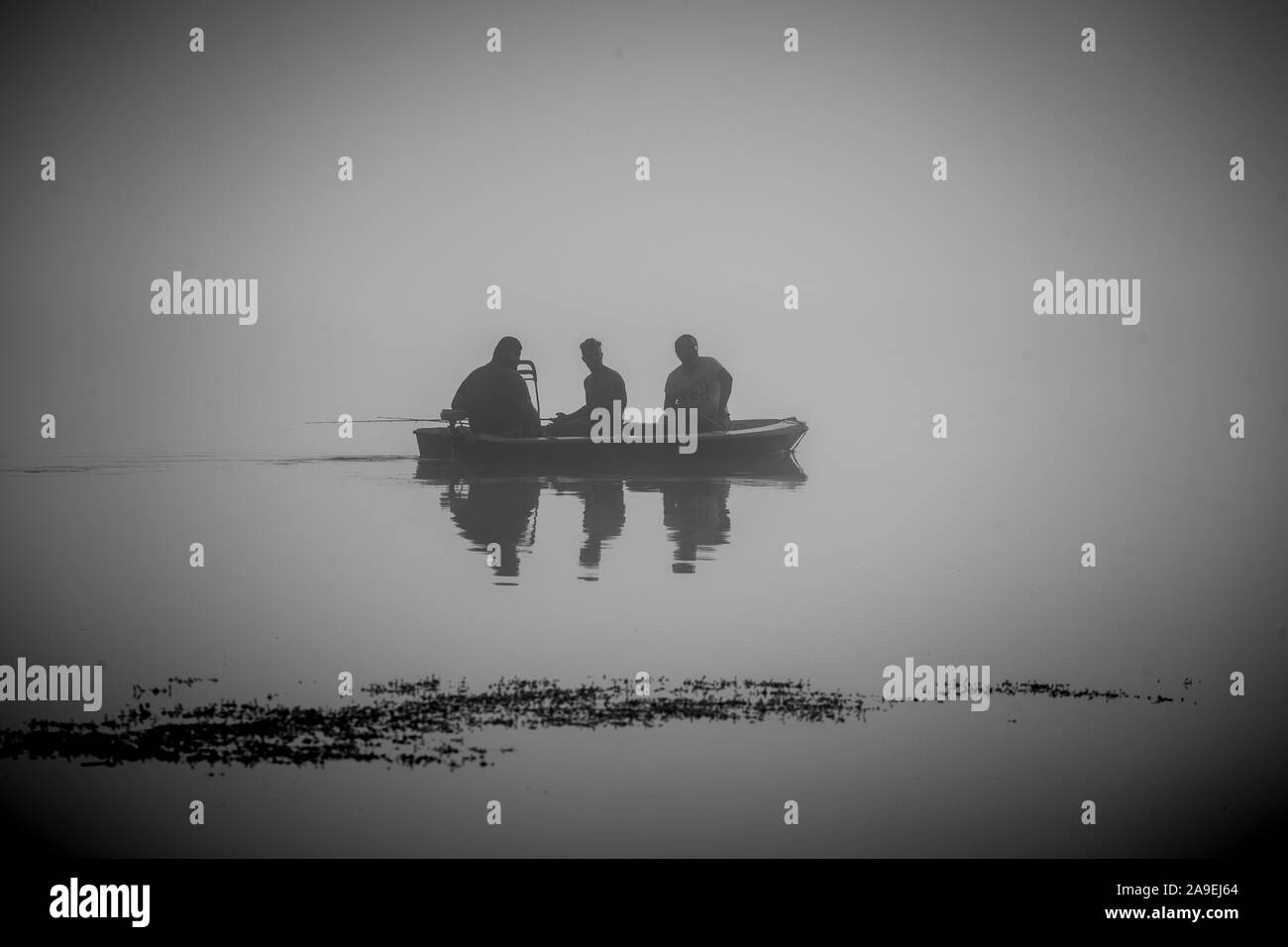 Fisherman in the fog Stock Photo