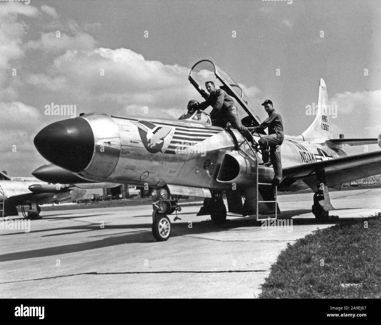 1958 - U.S. Air Force personnel assigned to the 119th Fighter Wing 'Happy Hooligans', North Dakota Air National Guard, Robert Groom and Neil Modin, photographed with their F-94 A/C Starfire aircraft at Hector Field, North Dakota. The 'Happy Hooligan' pilots flew the F-94 A/C Starfire aircraft from 1954-to-1960. Stock Photo