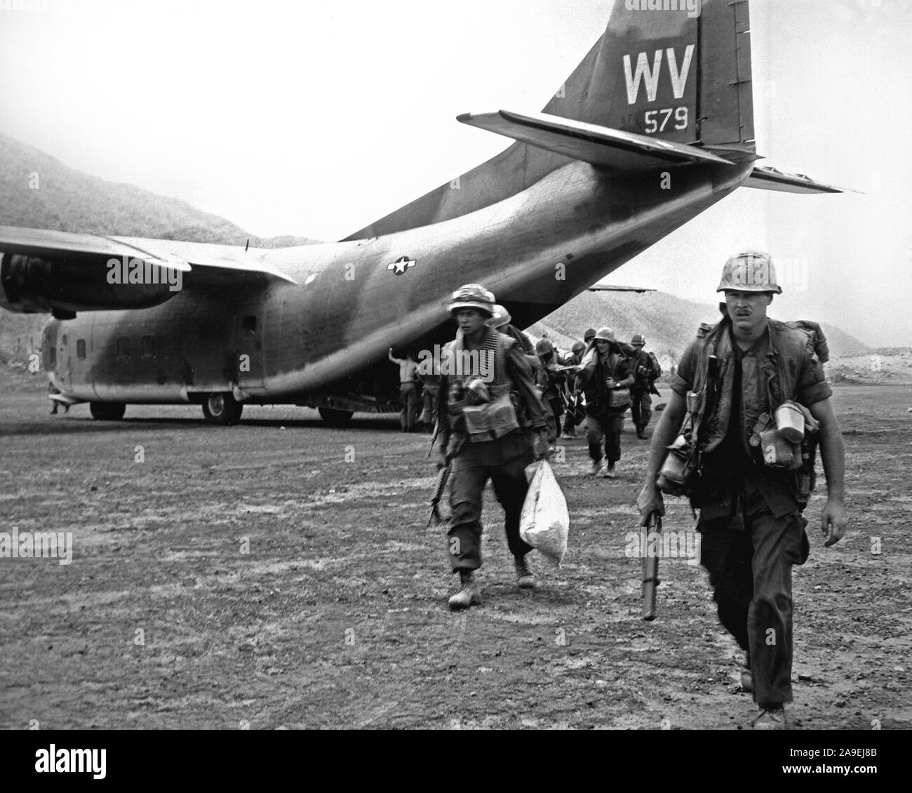 1968 - U.S. Marines head into combat after being airlifted to Calu by the C-123 Provider aircraft of the 311th Air Commando Squadron. Stock Photo